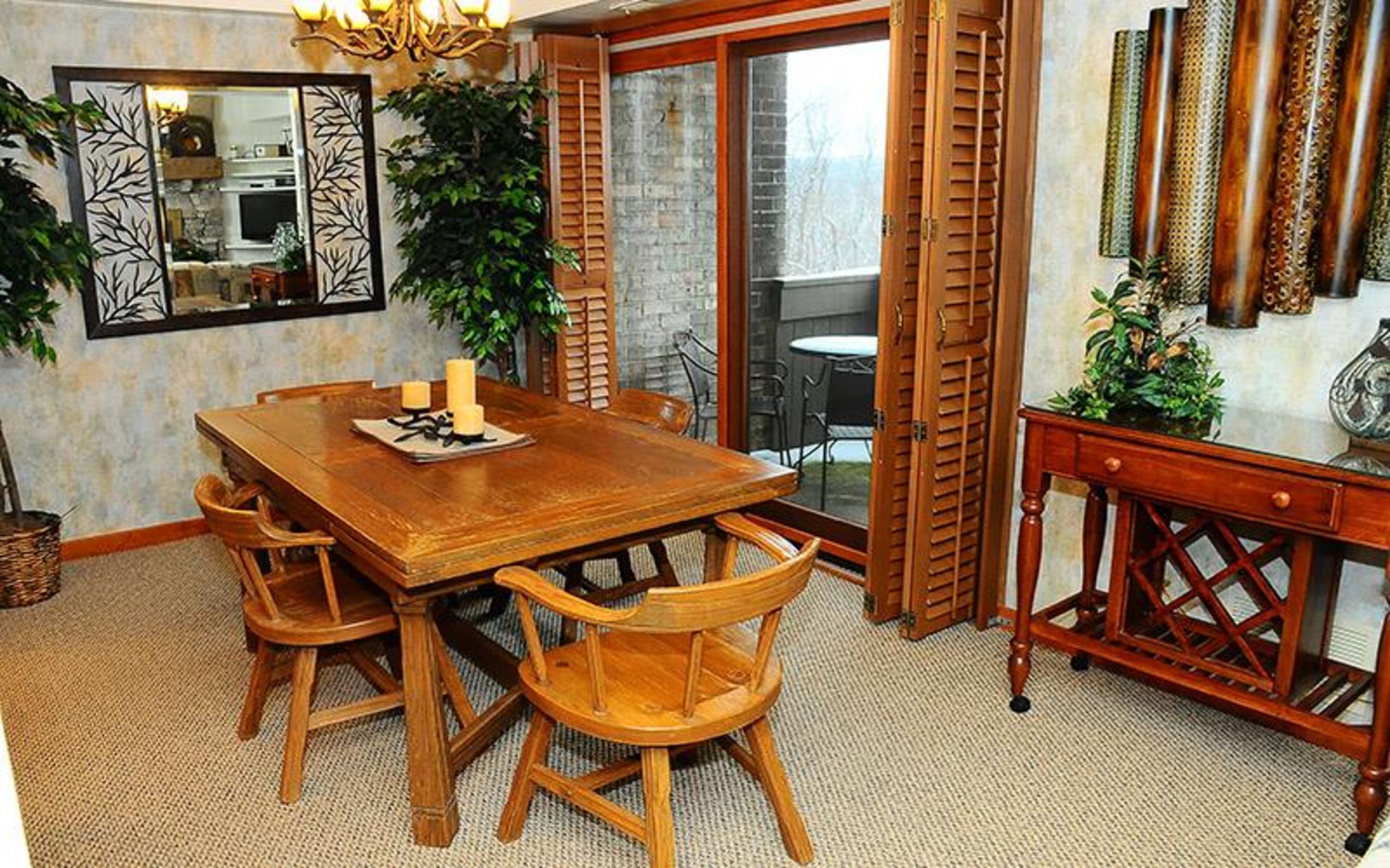 image The dining area is elegantly arranged with a wooden table, surrounded by chairs and adorned with decorative elements.