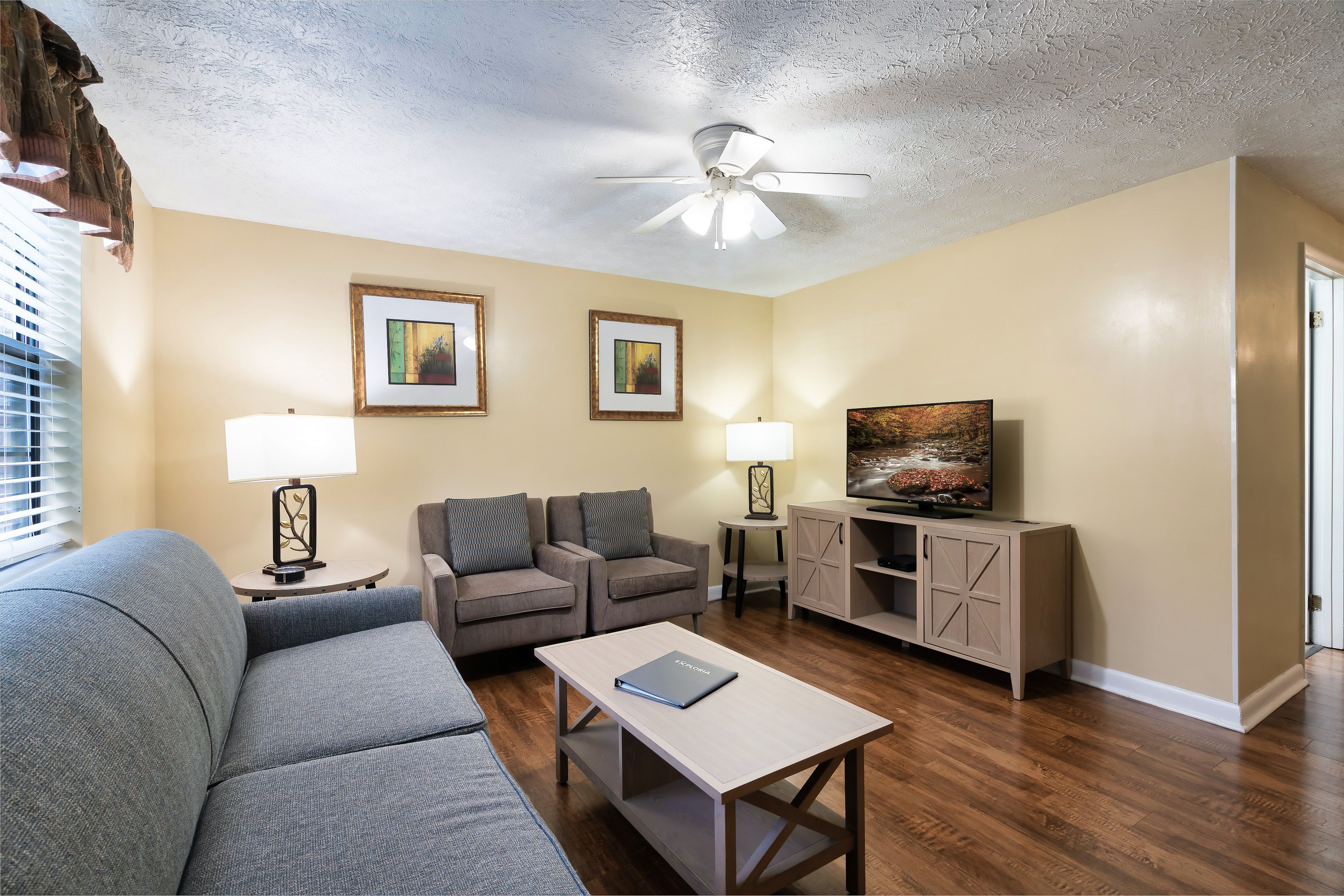 image Bright and inviting living room with smart TV and comfy seating for post-adventure lounging.