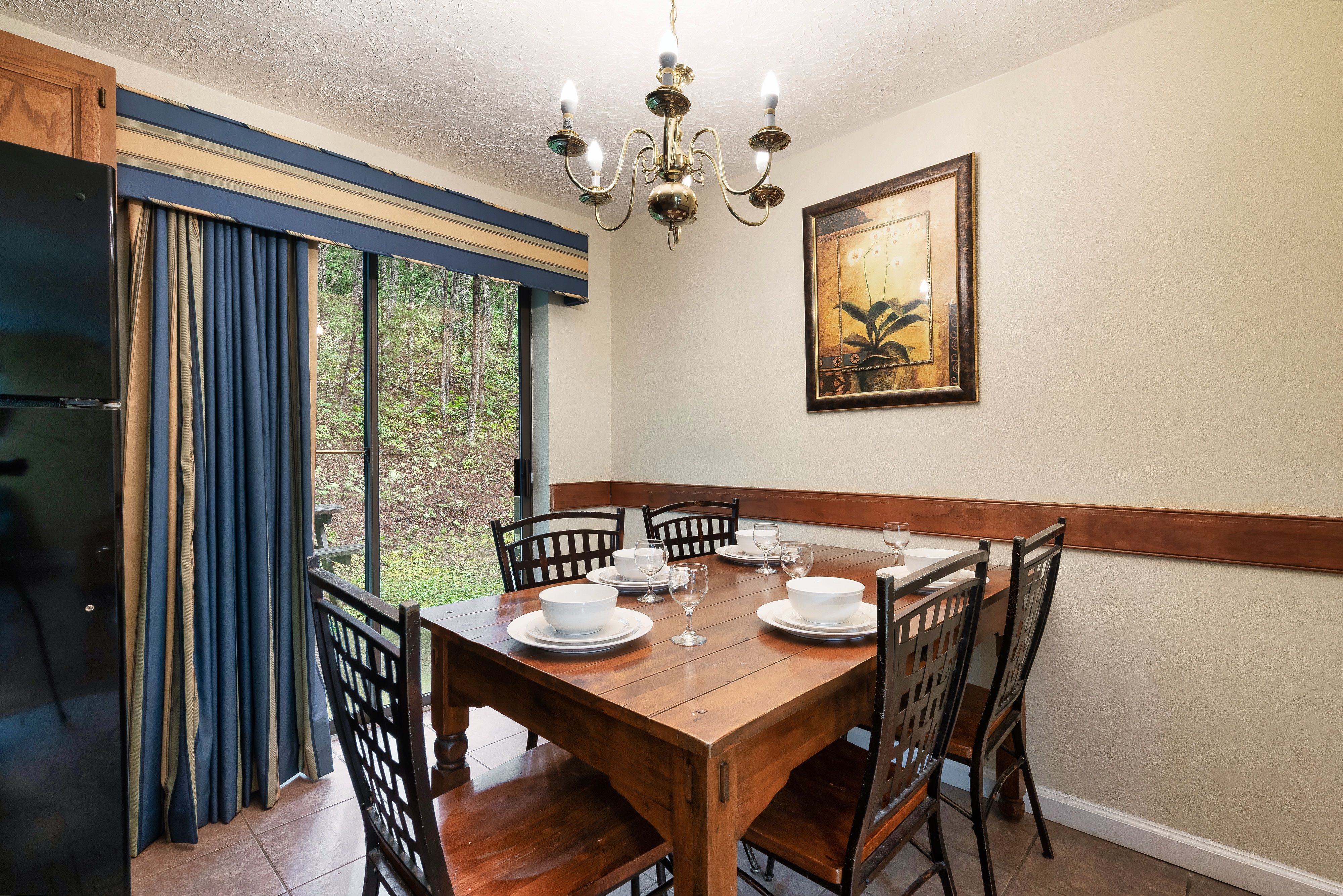 image Enjoy meals together in the dining area with forest views and warm cabin charm.