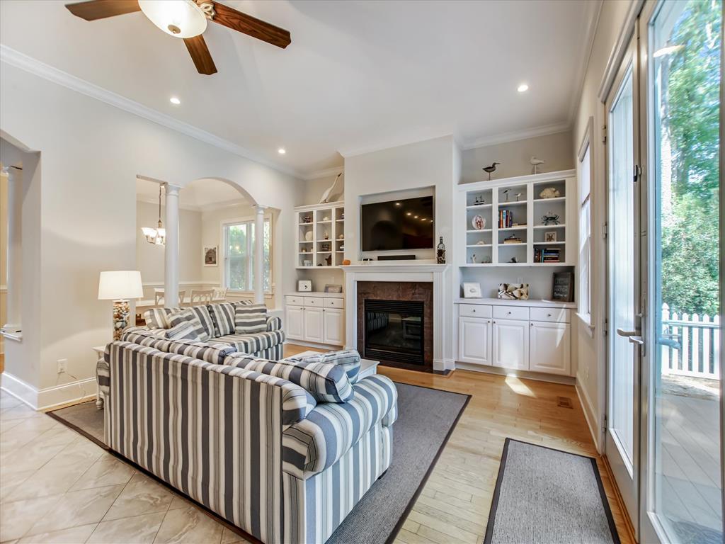 image Bright living space opens toward the deck and connects seamlessly to the kitchen and dining areas.