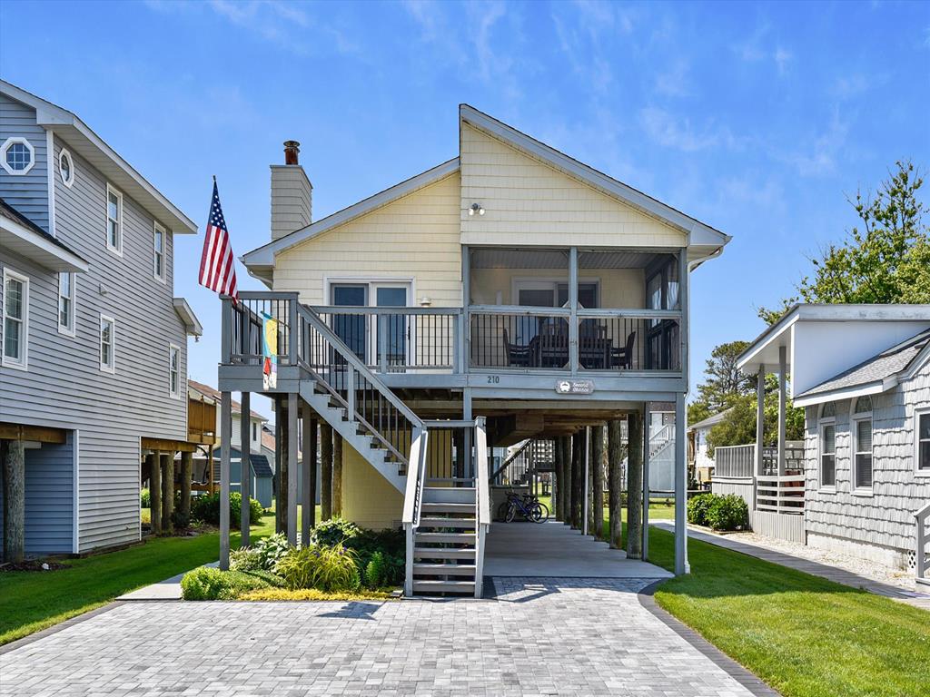 image Step onto the charming front porch and enjoy the inviting atmosphere of your beachside retreat.