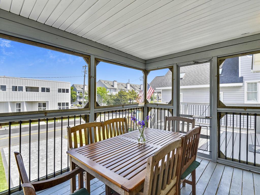 image Enjoy a casual meal or morning coffee at this charming table on the airy screened porch.