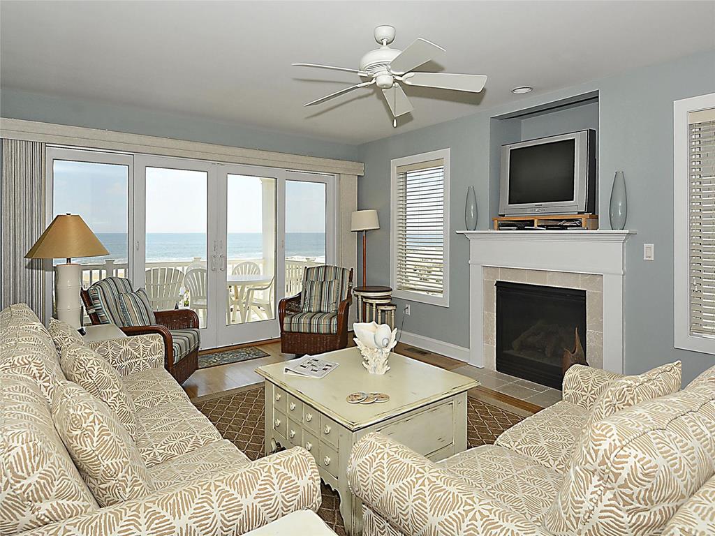 image Relax in the cozy living room, where comfort meets stunning ocean views.