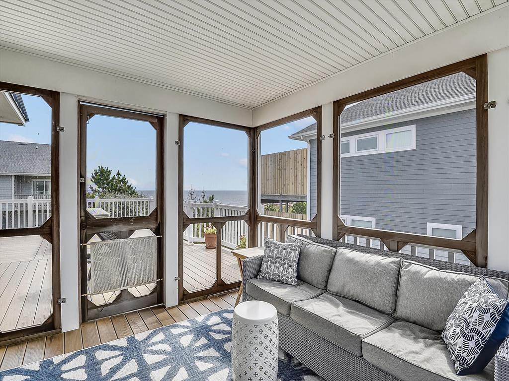 image Screened porch with comfortable seating and views of the surrounding outdoor area.