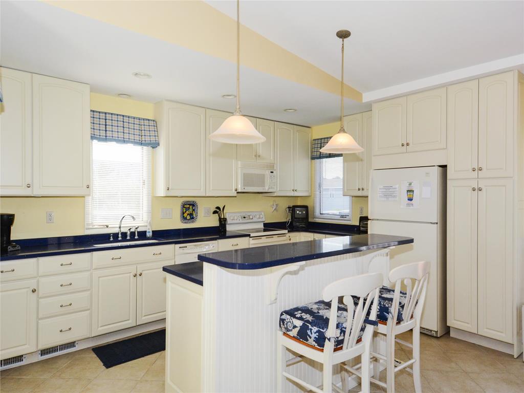 image Inside, the bright and spacious kitchen features modern appliances and a comfortable breakfast bar, perfect for family gatherings.