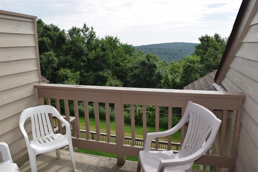 image Peaceful balcony overlooking rolling hills and endless sky, ideal for quiet moments and sunset views.