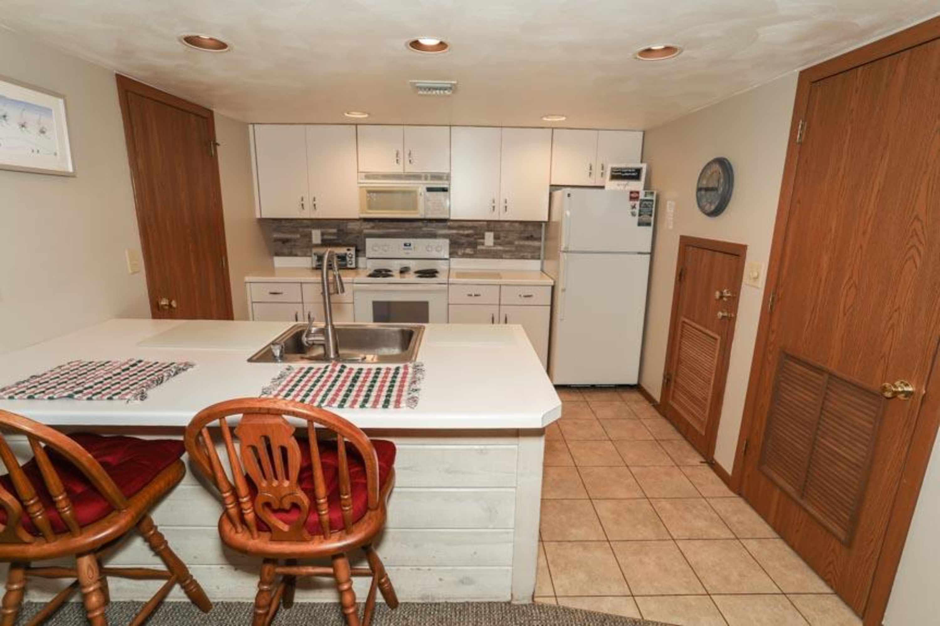 image Fully equipped kitchen with modern appliances and breakfast bar, ready for home-cooked meals.
