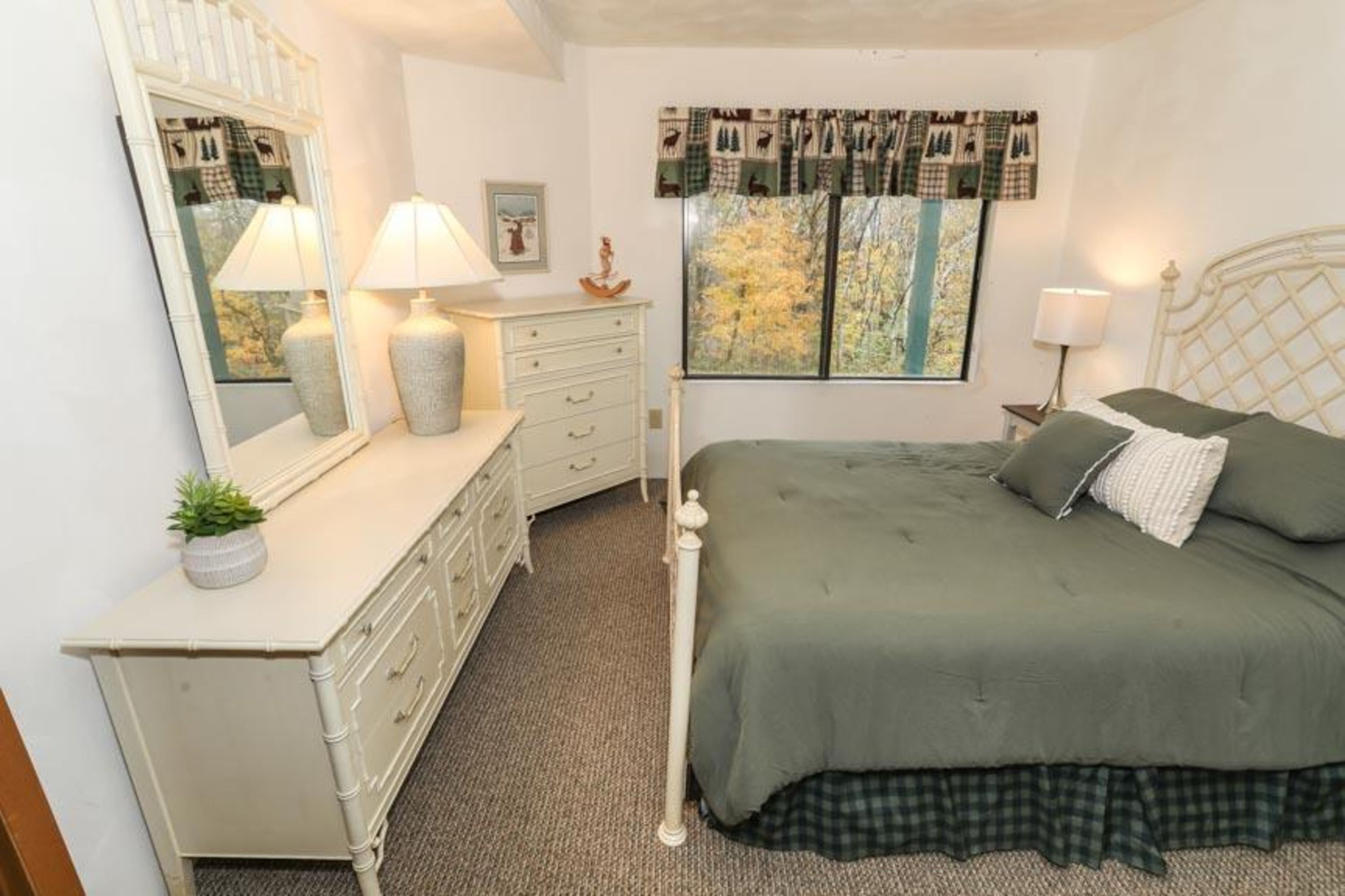 image Charming bedroom with queen bed, soft lighting, and serene decor for a restful retreat.