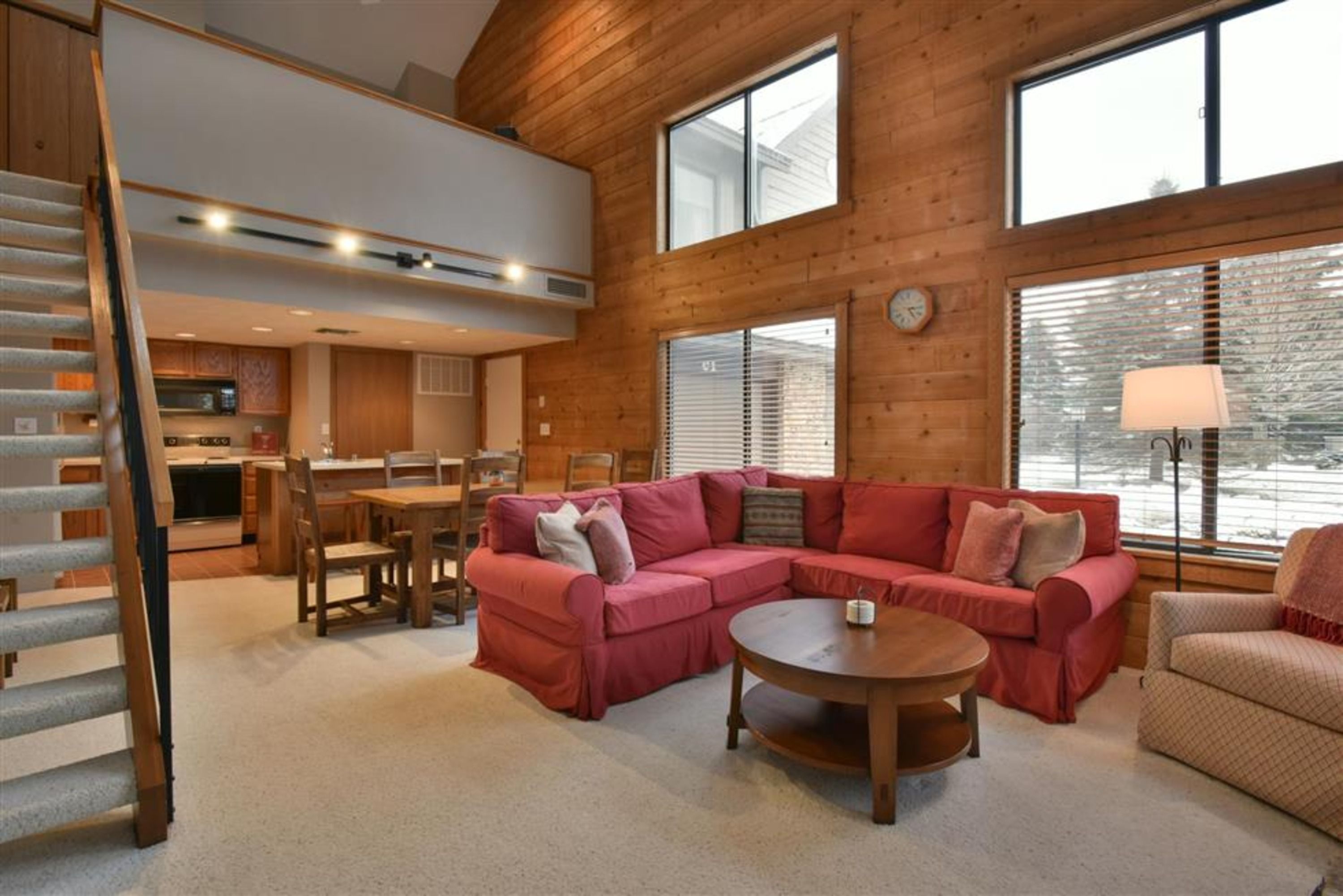 image Open-concept main level with rustic charm, combining living, dining, and easy access to the loft.