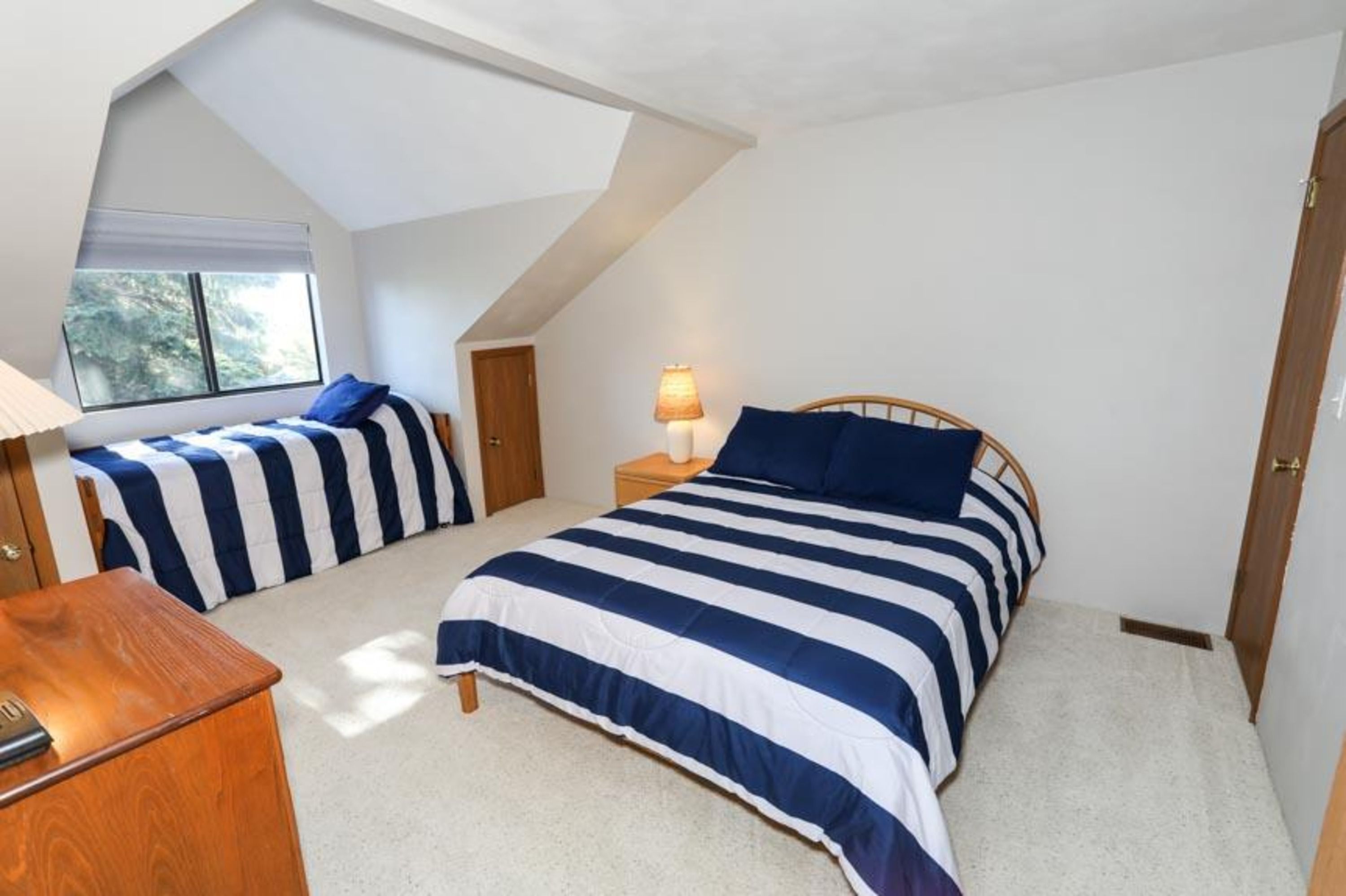 image Bright loft retreat featuring two twin beds—perfect for kids or extra guests.