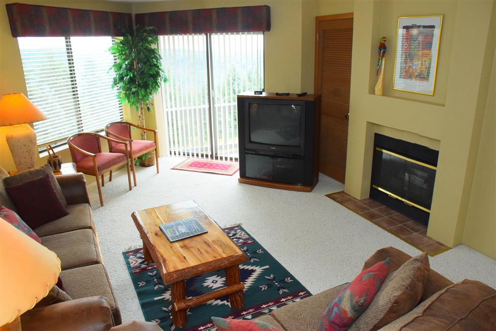 image Comfortable living space with fireplace whispers relaxation, connection, and a touch of mountain magic.
