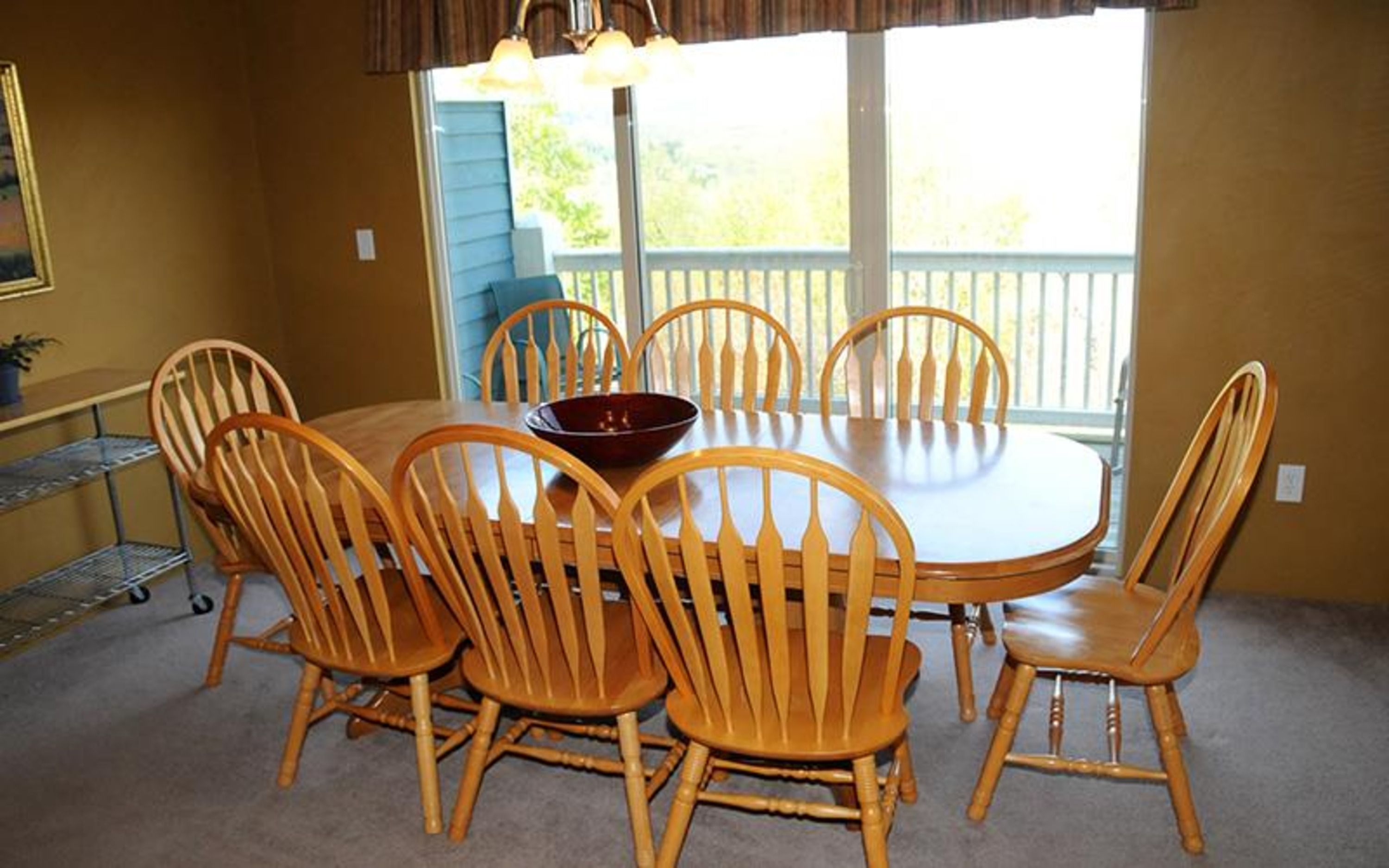 image Wooden dining set for six, with sliding doors that open to scenic views and fresh air.