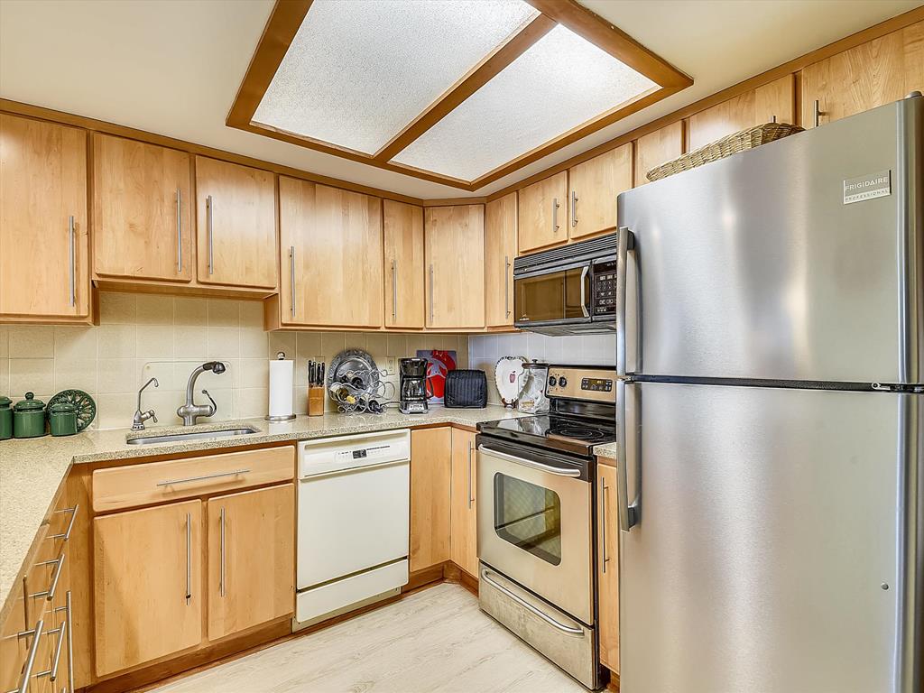 image Fully stocked kitchen with stainless steel appliances and dishwasher—perfect for easy family meals.