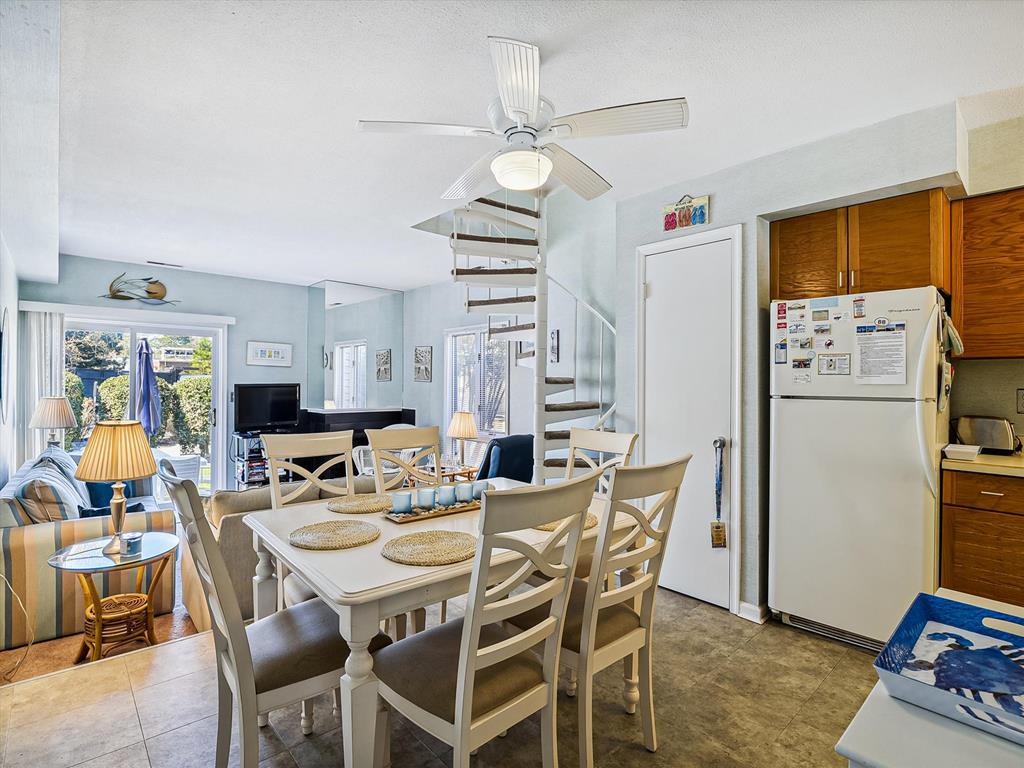 image Dine with style in this bright open-concept space, where comfort meets coastal charm.
