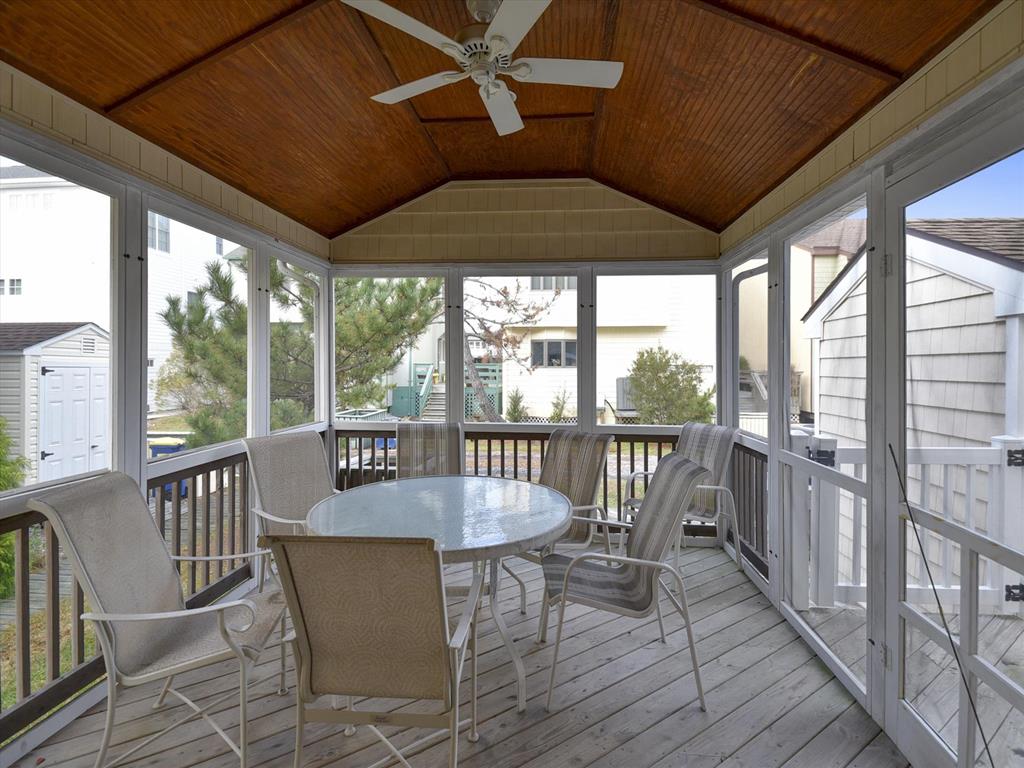 image Relax year-round in the screened porch, perfect for morning coffee or evening chats.