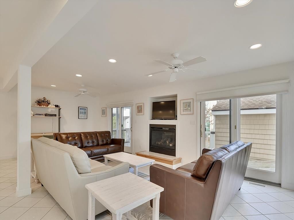 image Bright and open living area with plenty of seating for group gatherings and movie nights.