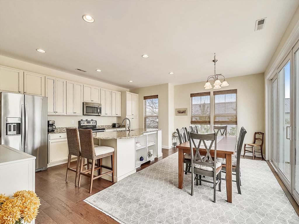 image Gather around in this spacious kitchen and dining area, perfect for family meals and joyful conversations.