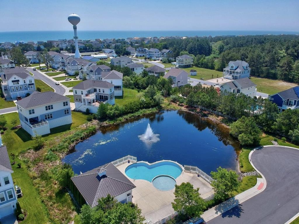 image Take a dip in the inviting community pool, surrounded by lush greenery and tranquil waters.