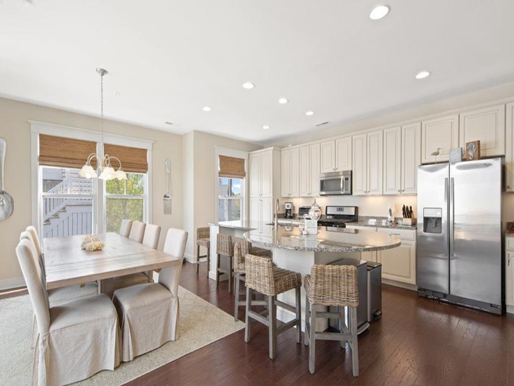 image Gather around the modern kitchen island, where meals and memories await.