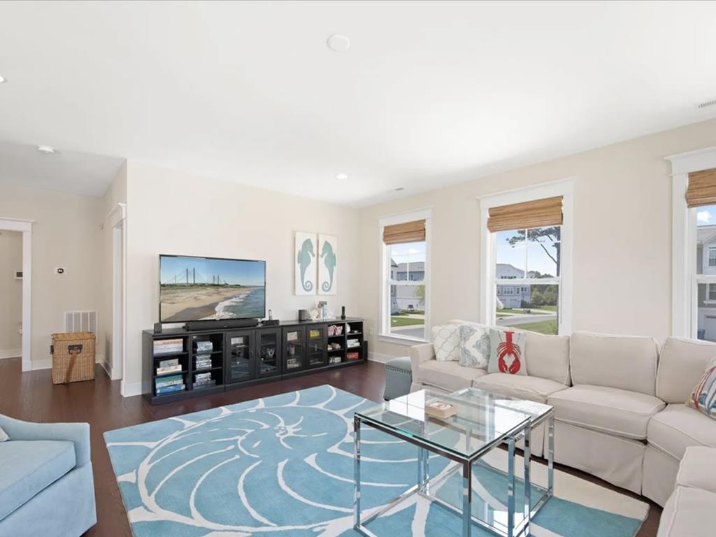 image Unwind in the cozy living area, featuring a plush sofa and coastal-inspired decor.