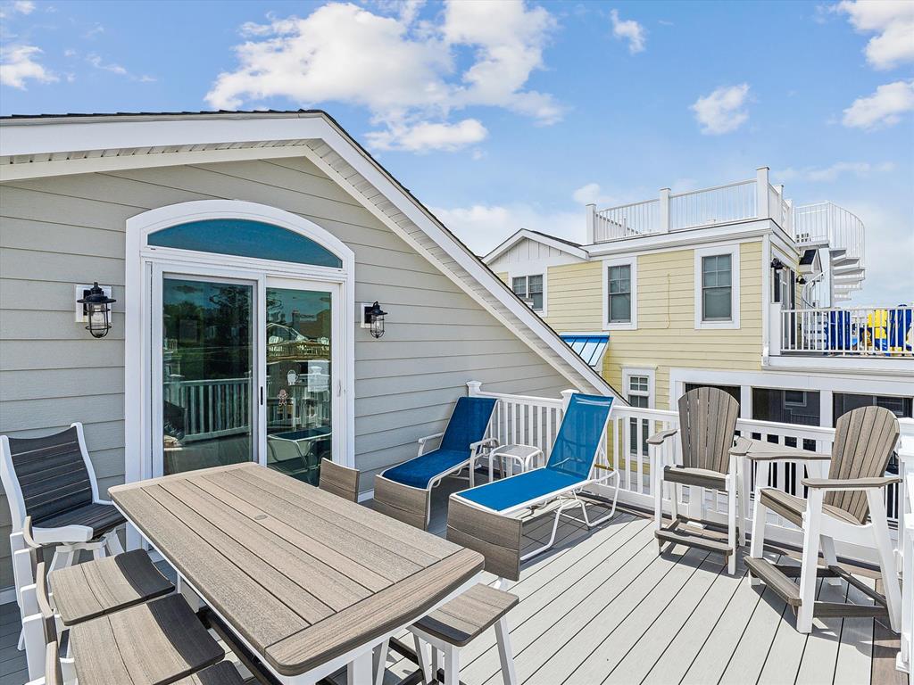 image Relax on the spacious deck, basking in the sun with comfortable seating and a refreshing ocean breeze.