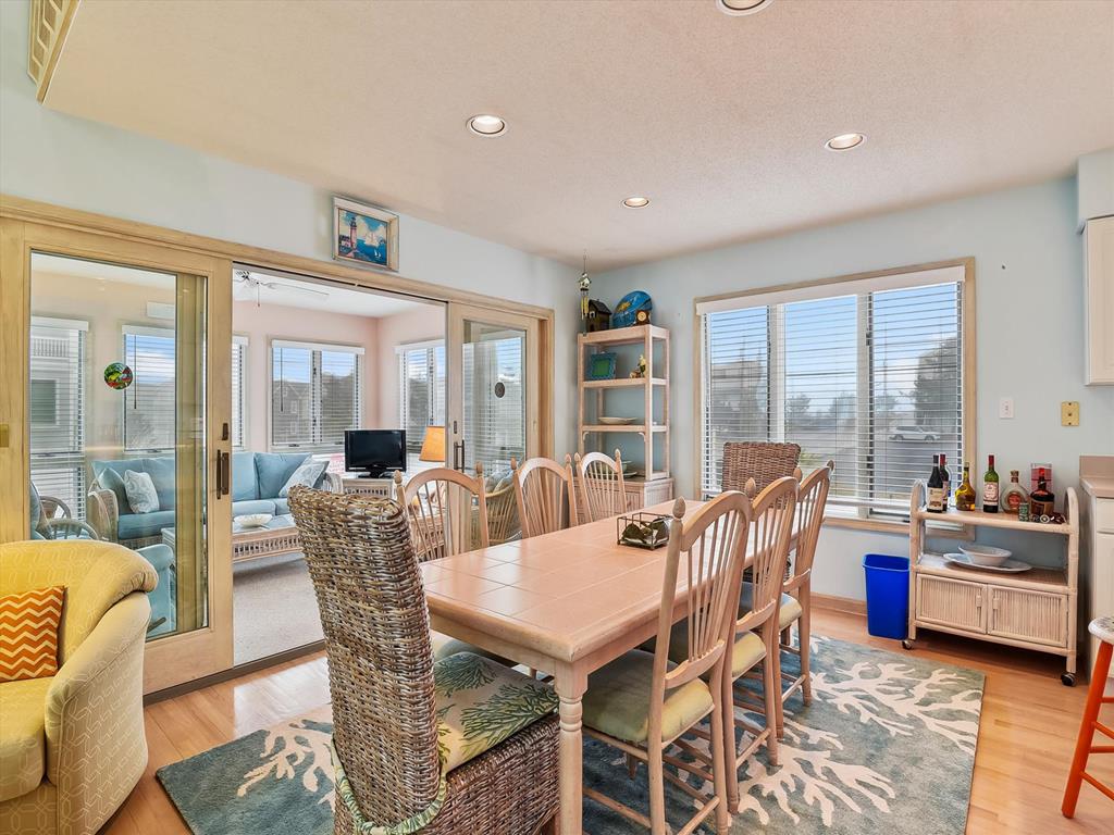 image Gather around the spacious dining table, perfect for family meals, with natural light streaming in.