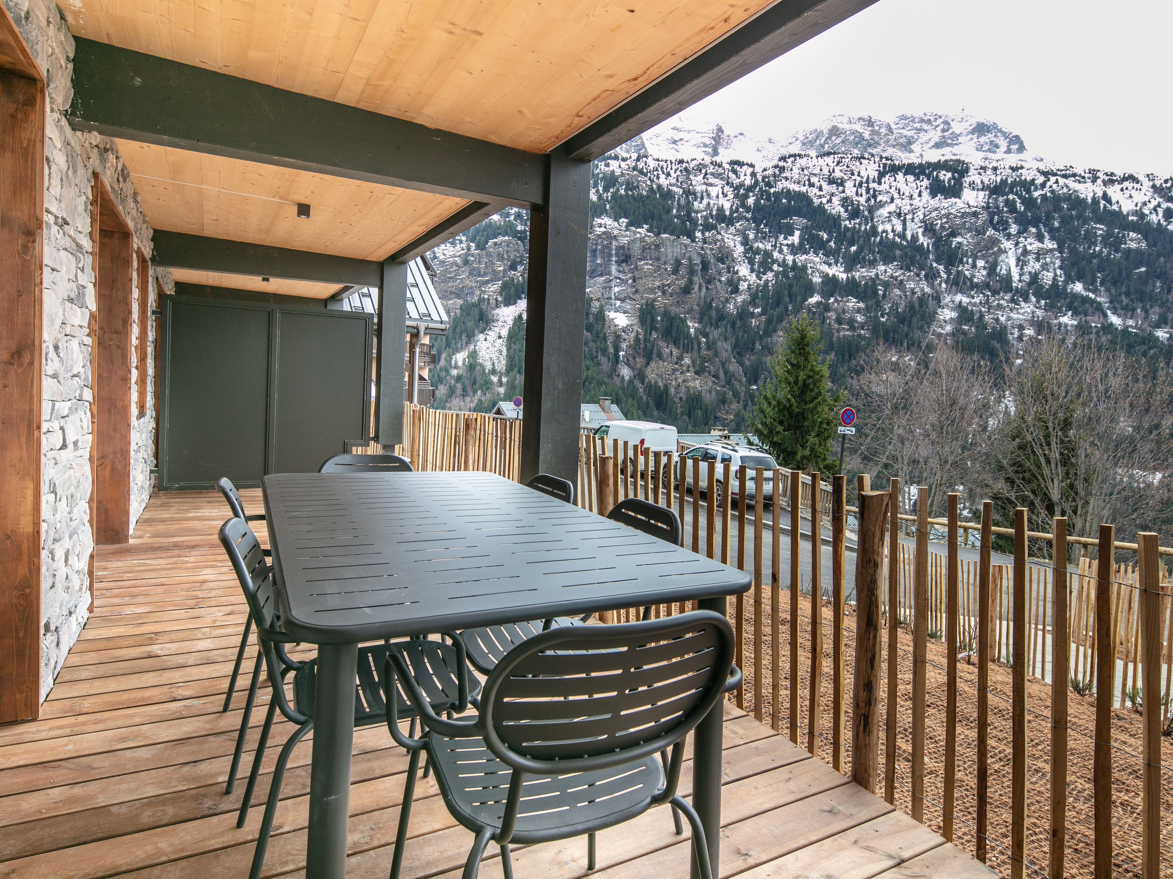 image Gather around the spacious dining table on your outdoor terrace, perfect for enjoying meals in the fresh alpine air.