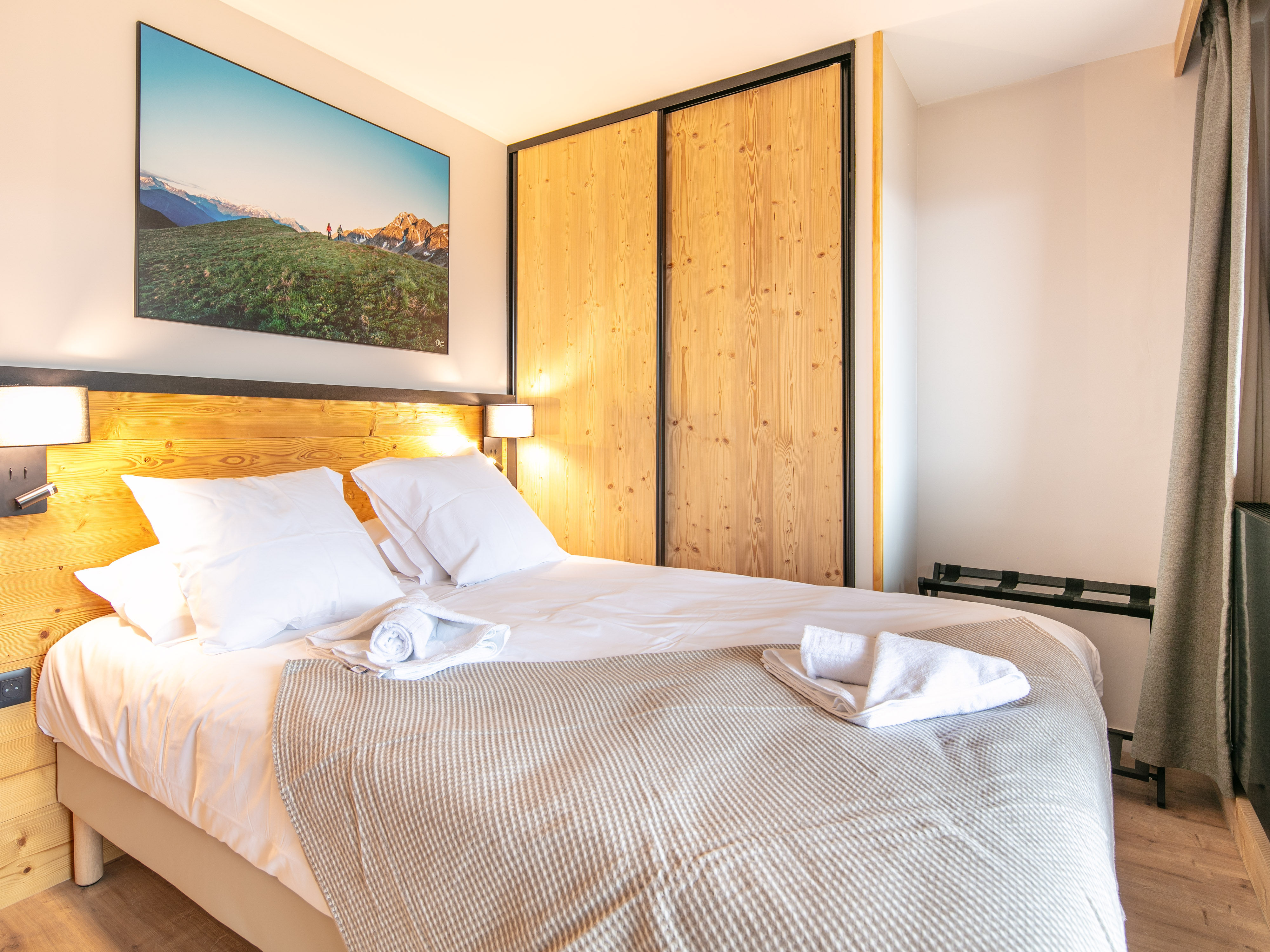 image Sink into the comfort of a beautifully styled bedroom, where relaxation meets alpine charm.