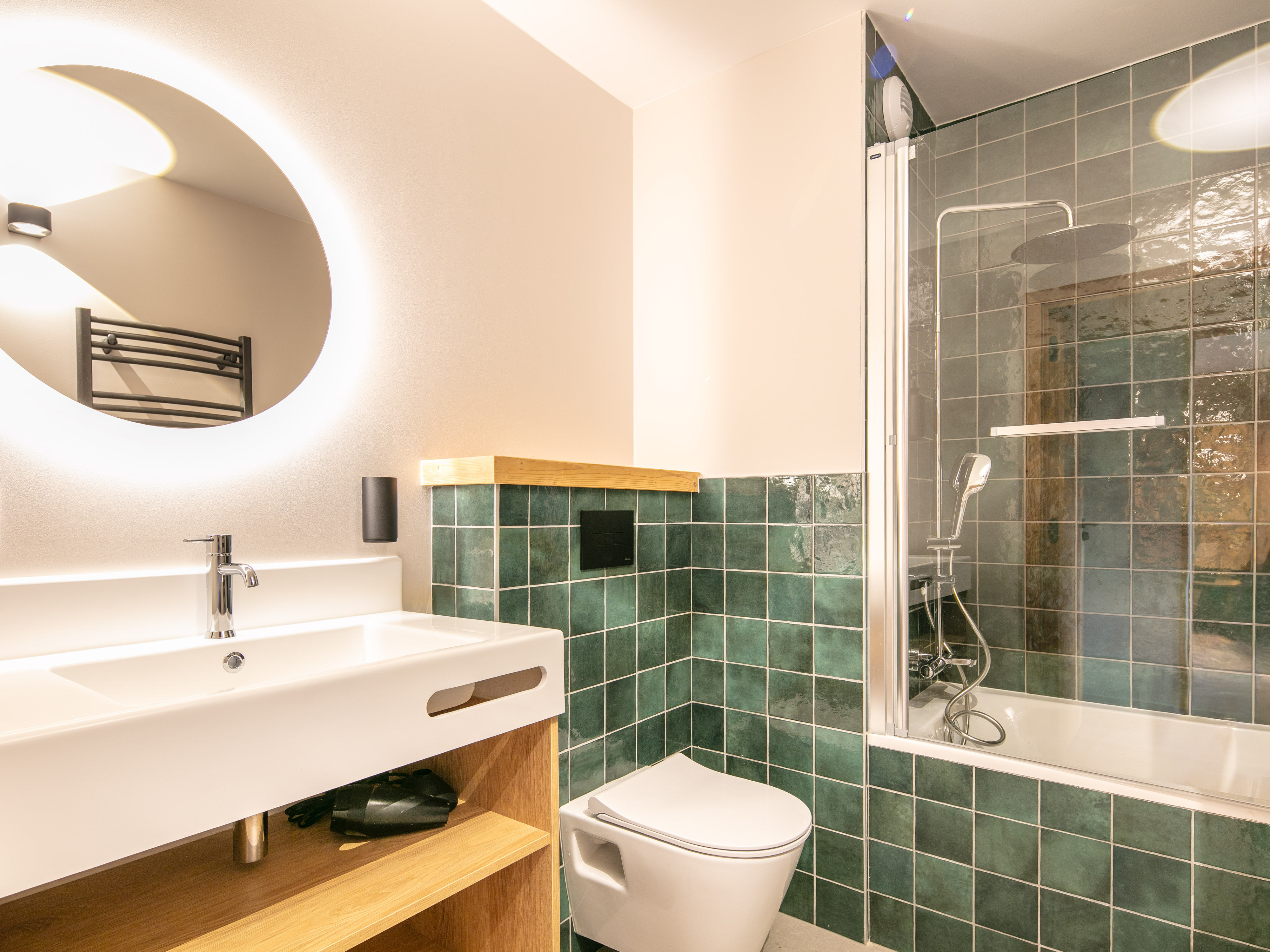 image Enjoy a refreshing shower in a stylish bathroom, featuring a unique round mirror.