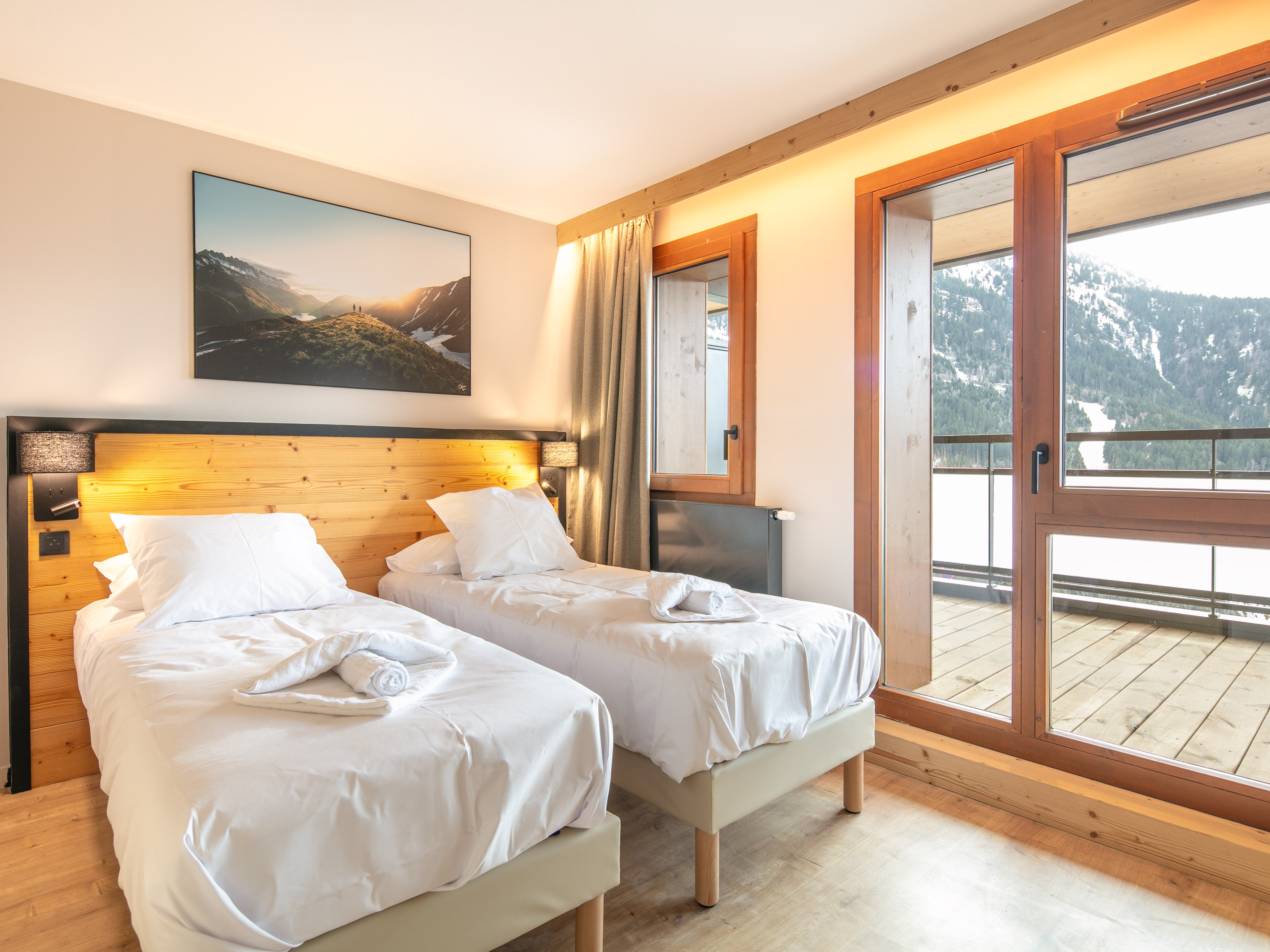 image Rest easy in cozy twin beds, with natural light pouring through large windows.