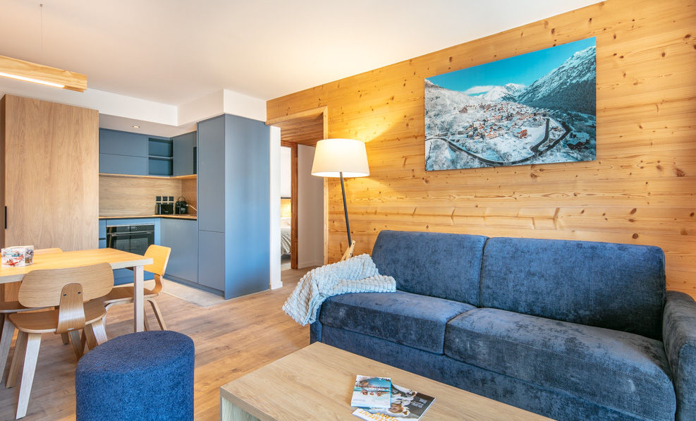 image The modern living area combines a comfortable sofa and dining space, seamlessly blending functionality with stylish decor and wooden accents.