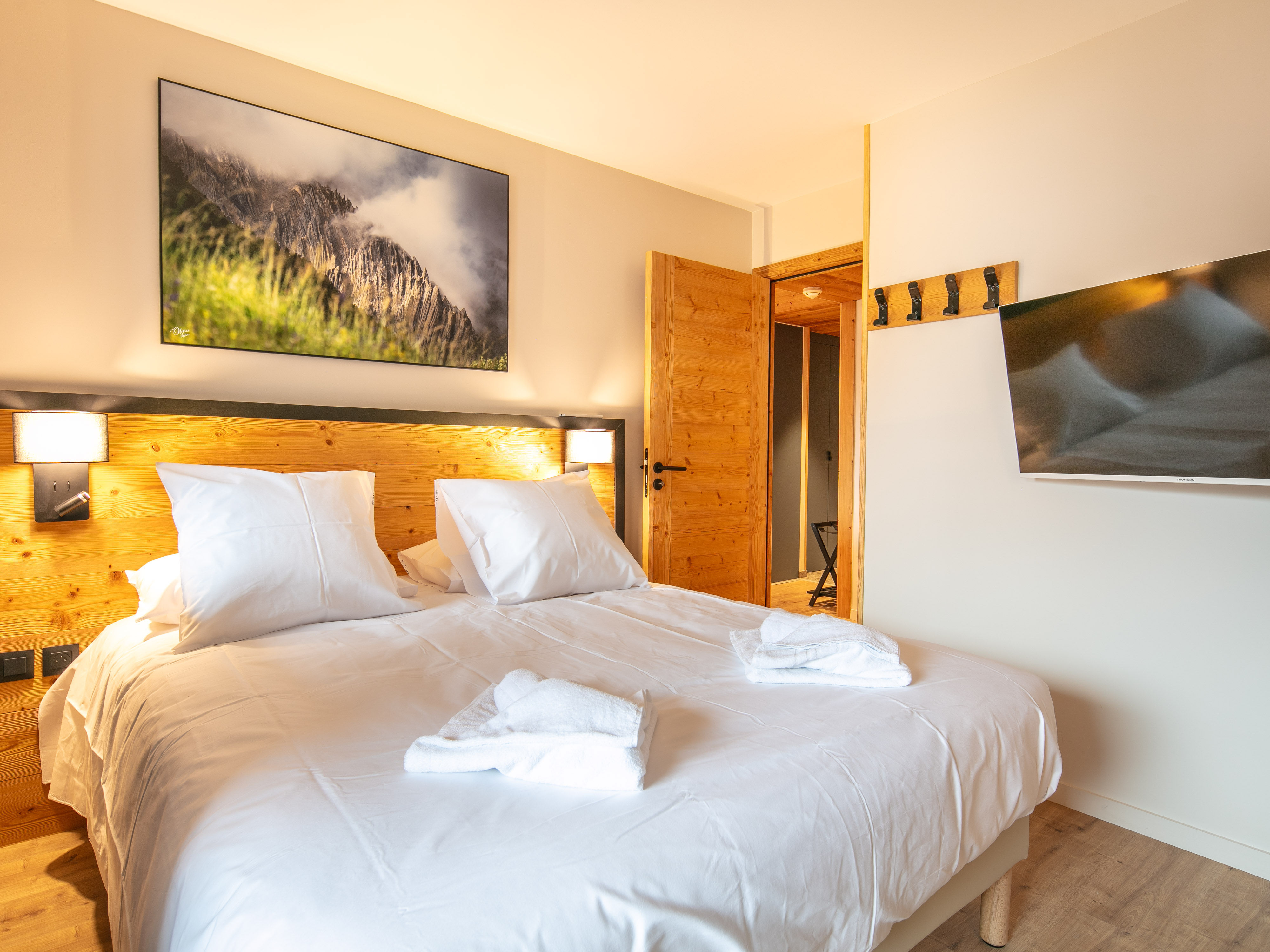 image Relax in this cozy double bed adorned with fluffy pillows, topped with ambient lighting for a perfect night’s sleep.