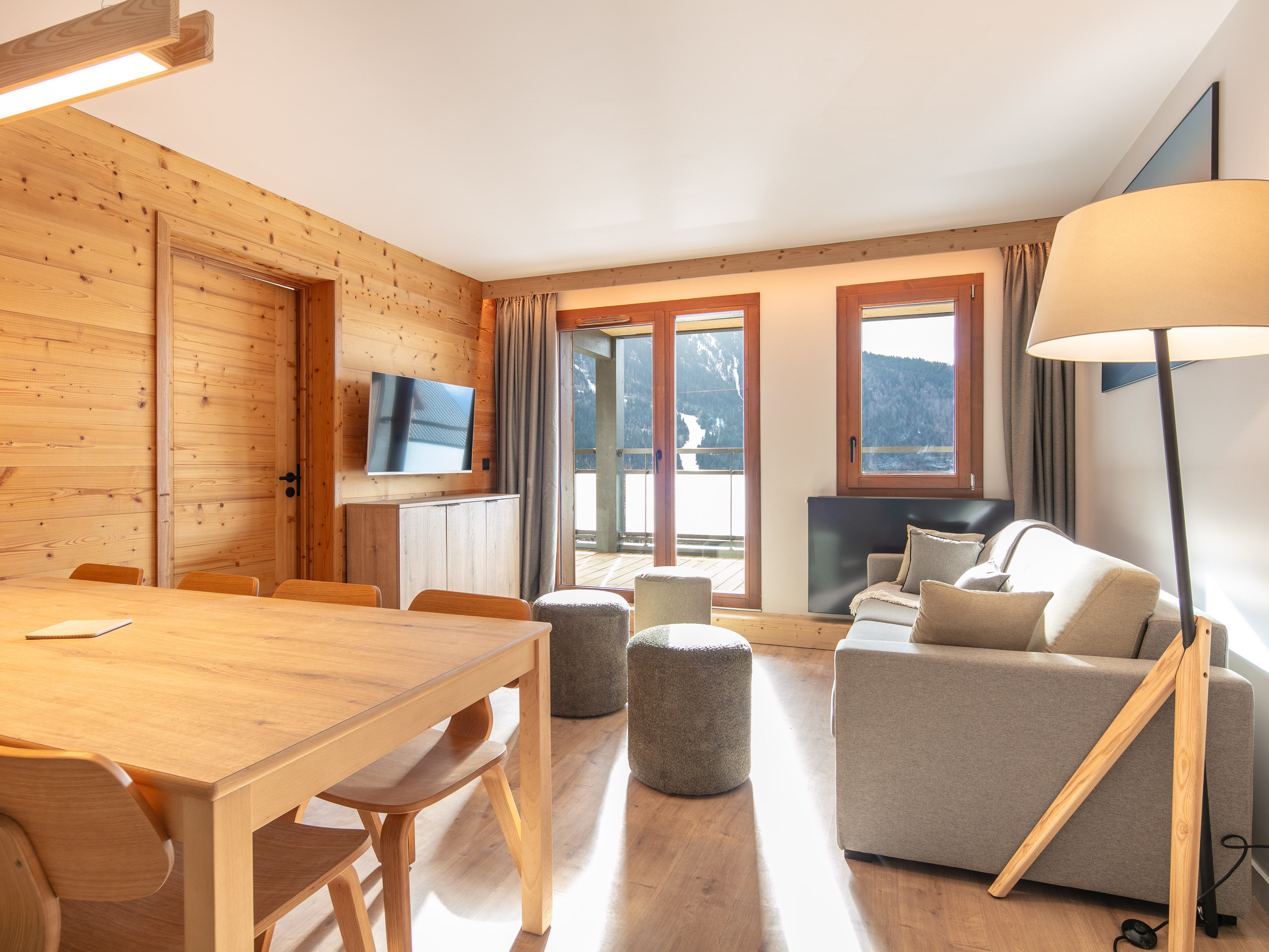 image Gather around the dining table after a day of adventure, with a stunning wood-panelled backdrop to complement your meals.