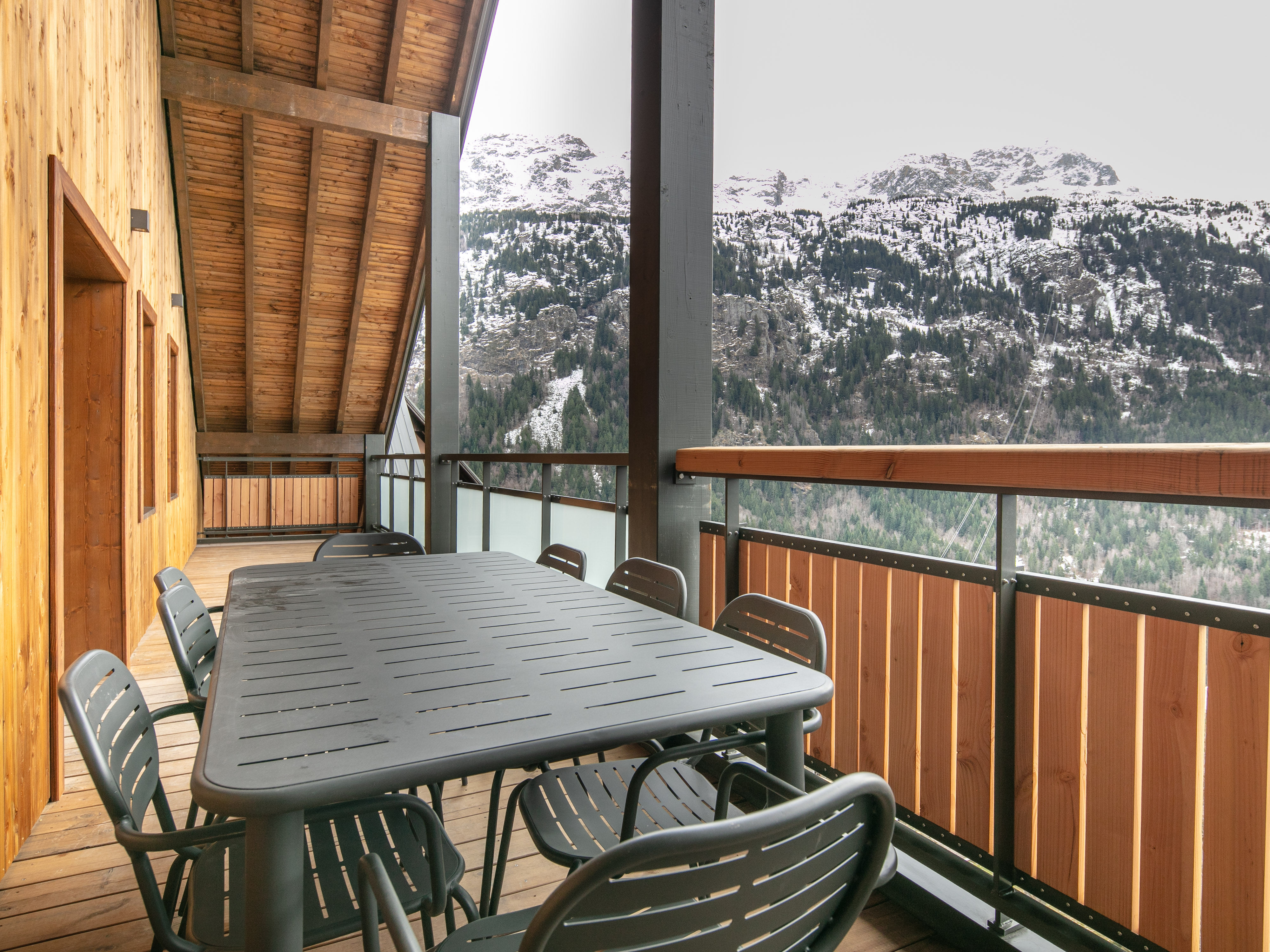 image Gather around the spacious outdoor table on your private balcony, perfect for al fresco dining.