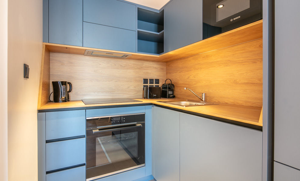 image This modern kitchen is designed with sleek cabinetry and functional appliances, providing everything needed for cooking and dining.