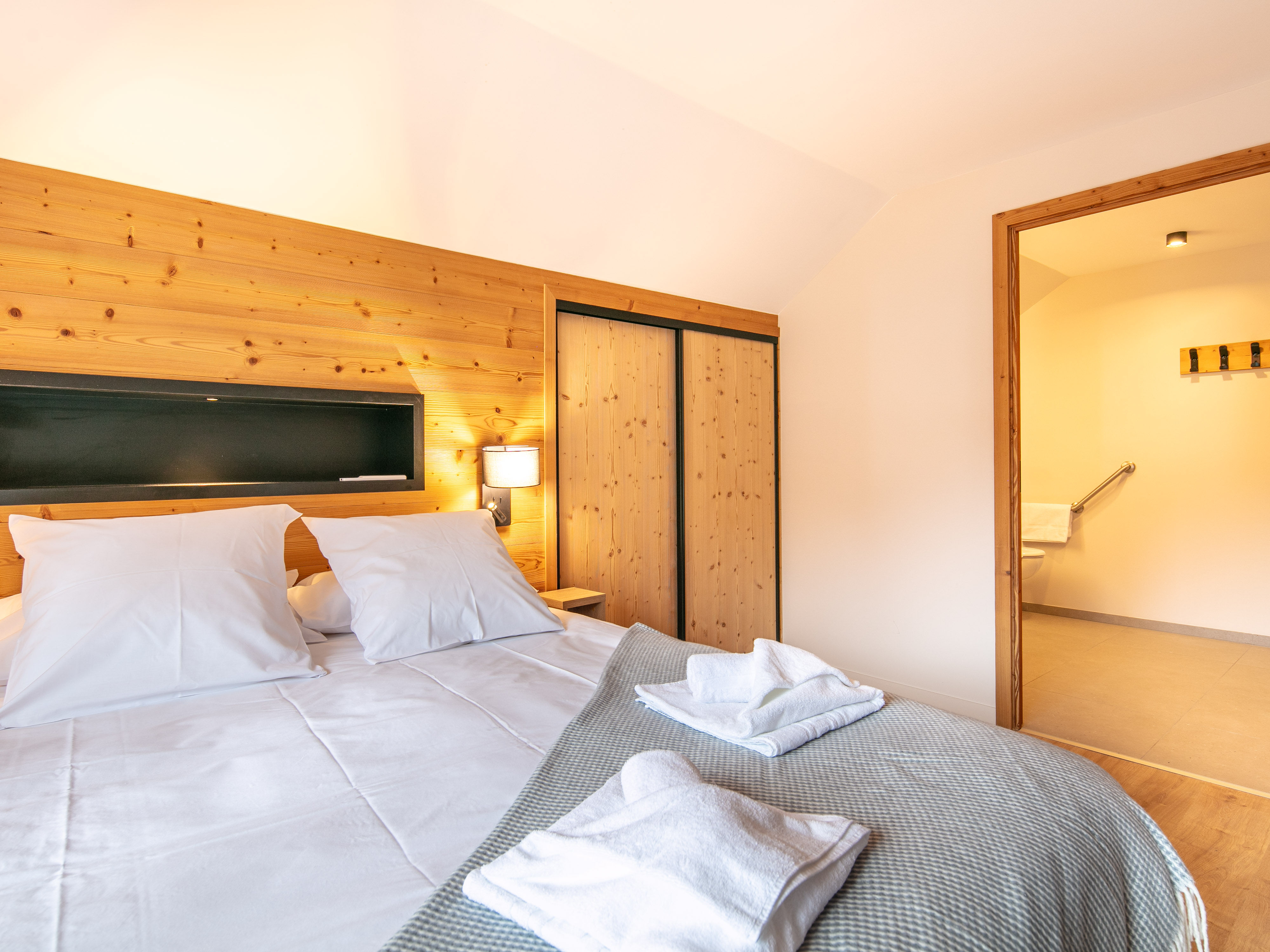 image Sink into the plush bed adorned with fresh linens, promising restful nights in a tranquil setting.