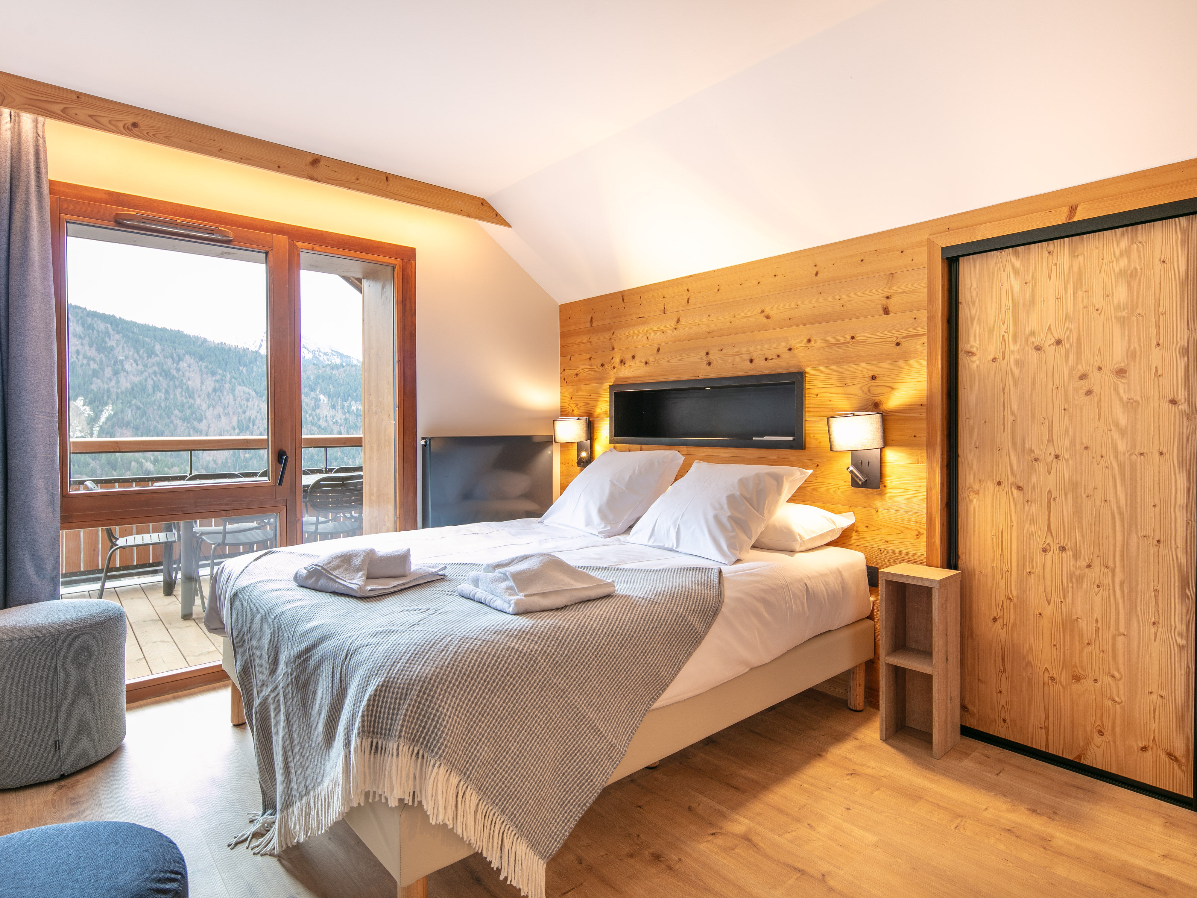 image Unwind in a tranquil bedroom with a plush bed and access to a private balcony.