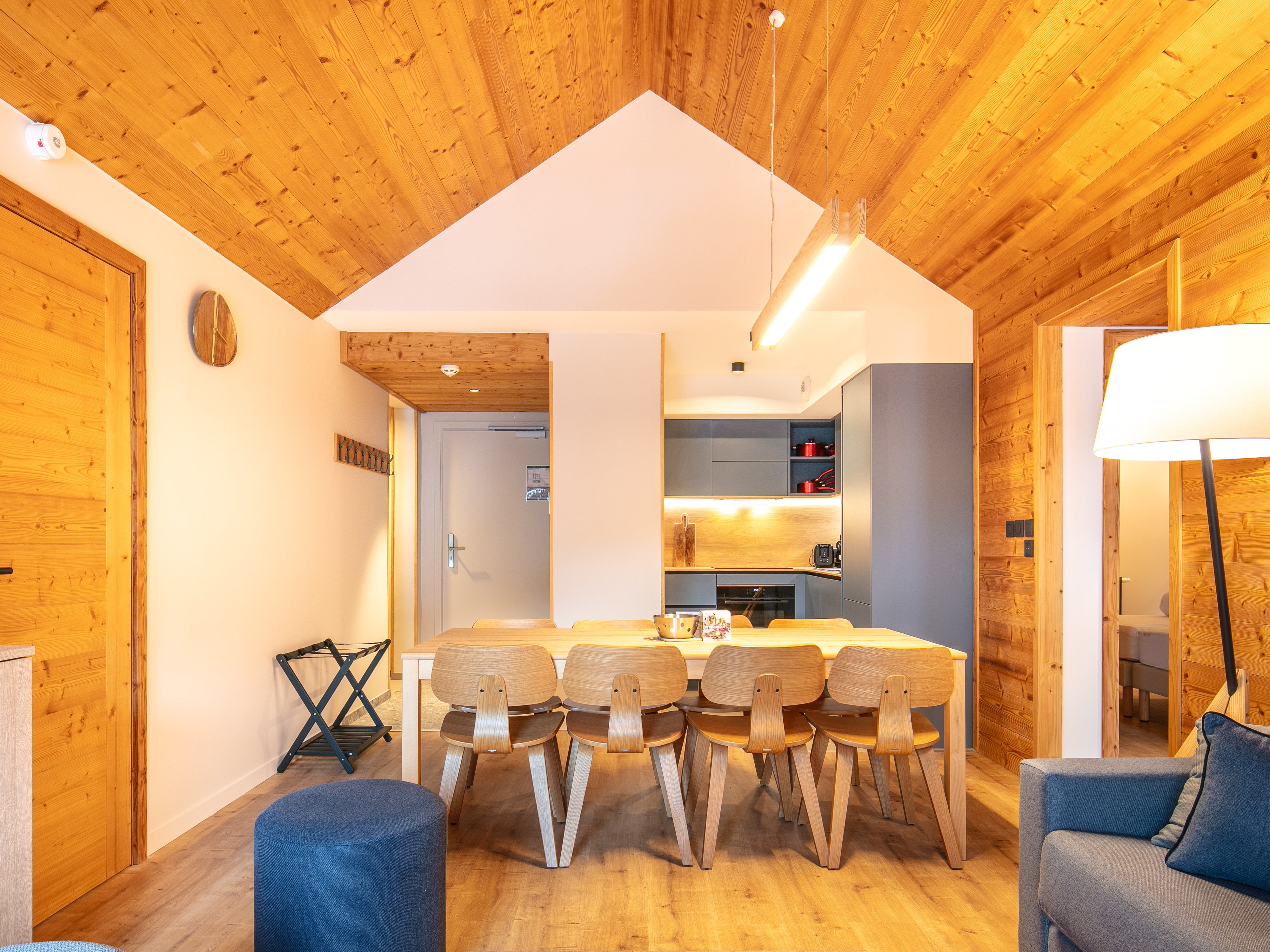 image Gather around the modern dining table, where wood accents create a cozy, inviting atmosphere.