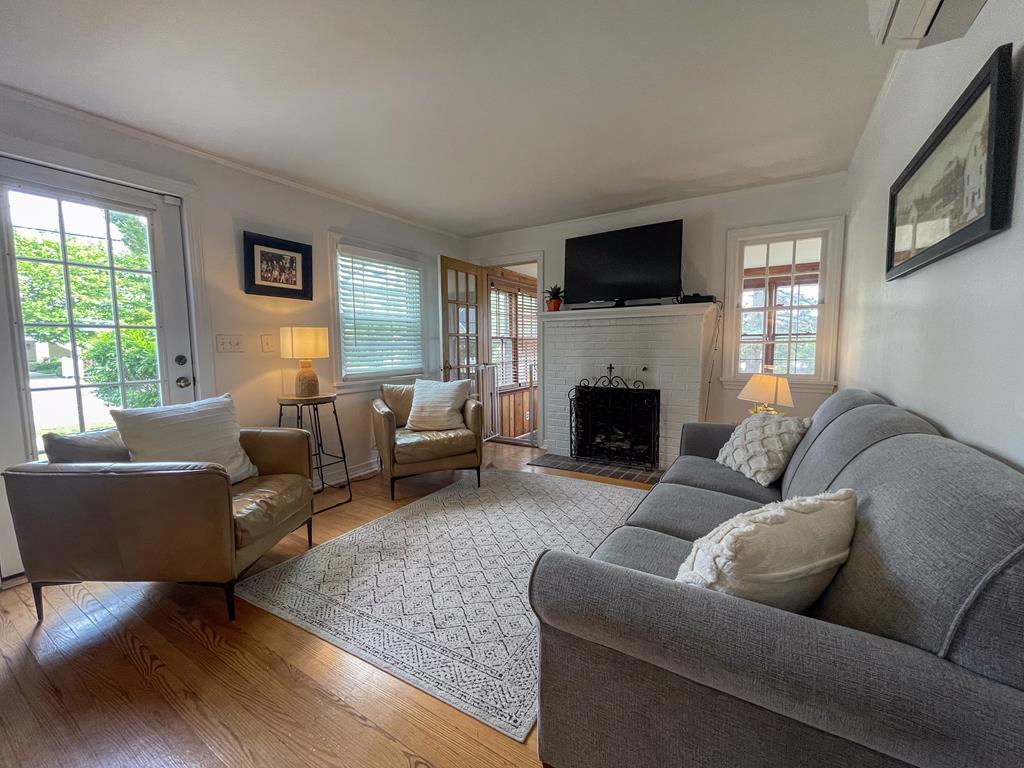 image Gather in the bright, inviting living room where hardwood floors, soft couches, and a flickering smart TV create the perfect setting for evening board games or lazy movie nights.