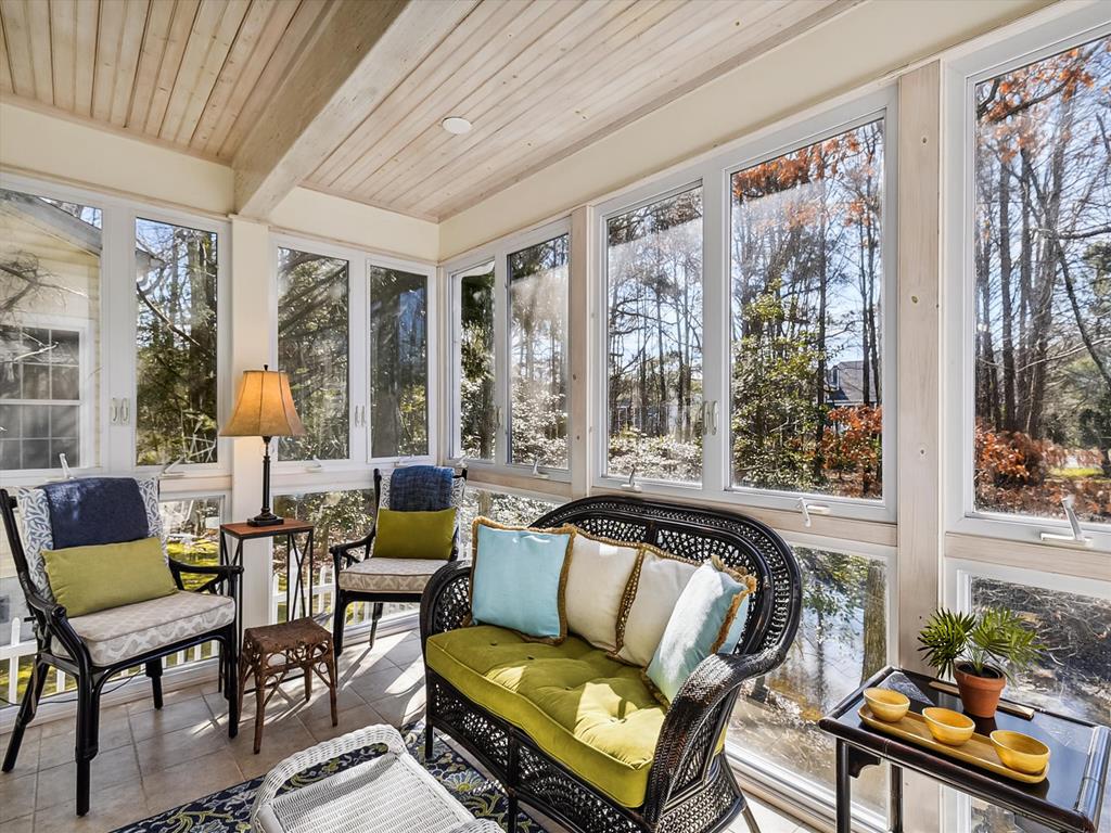 image Savor morning coffee or evening breezes in the airy four-season sunroom, filled with natural light and cozy seating.