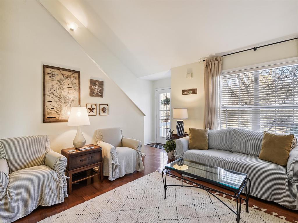 image The cozy living room offers plush seating and warm natural light, perfect for relaxing evenings or family movie nights.