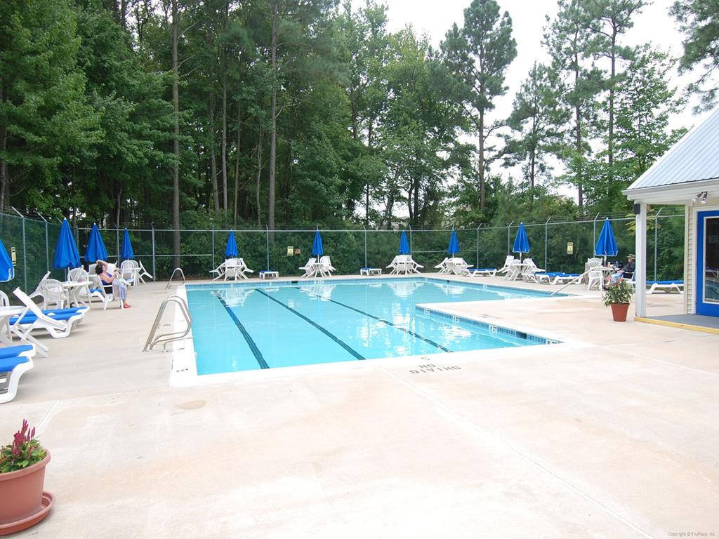 image Enjoy access to the nearby community pool with lounge chairs, umbrellas, and space to relax and cool off in the sun.