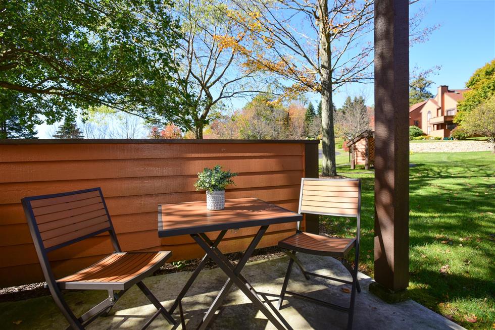 image Peaceful outdoor patio surrounded by greenery, offering a quiet spot to soak in the fresh mountain air.