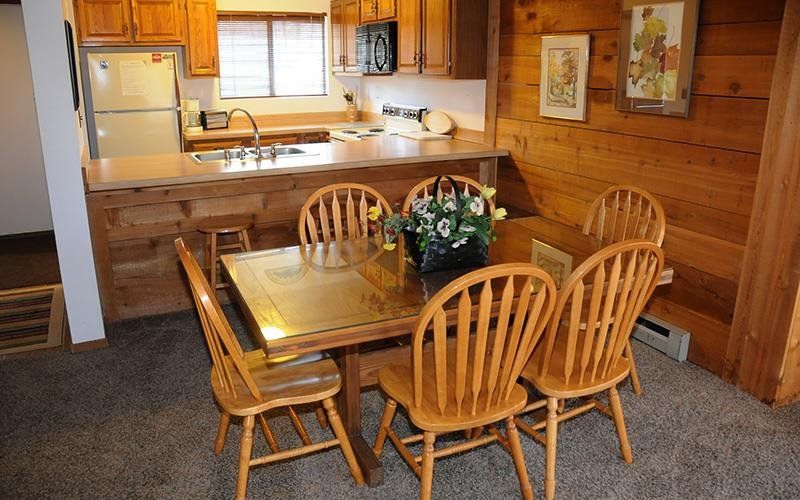 image Dining area set against classic wood accents creates the ideal setting for memorable family meals and laughter-filled evenings.