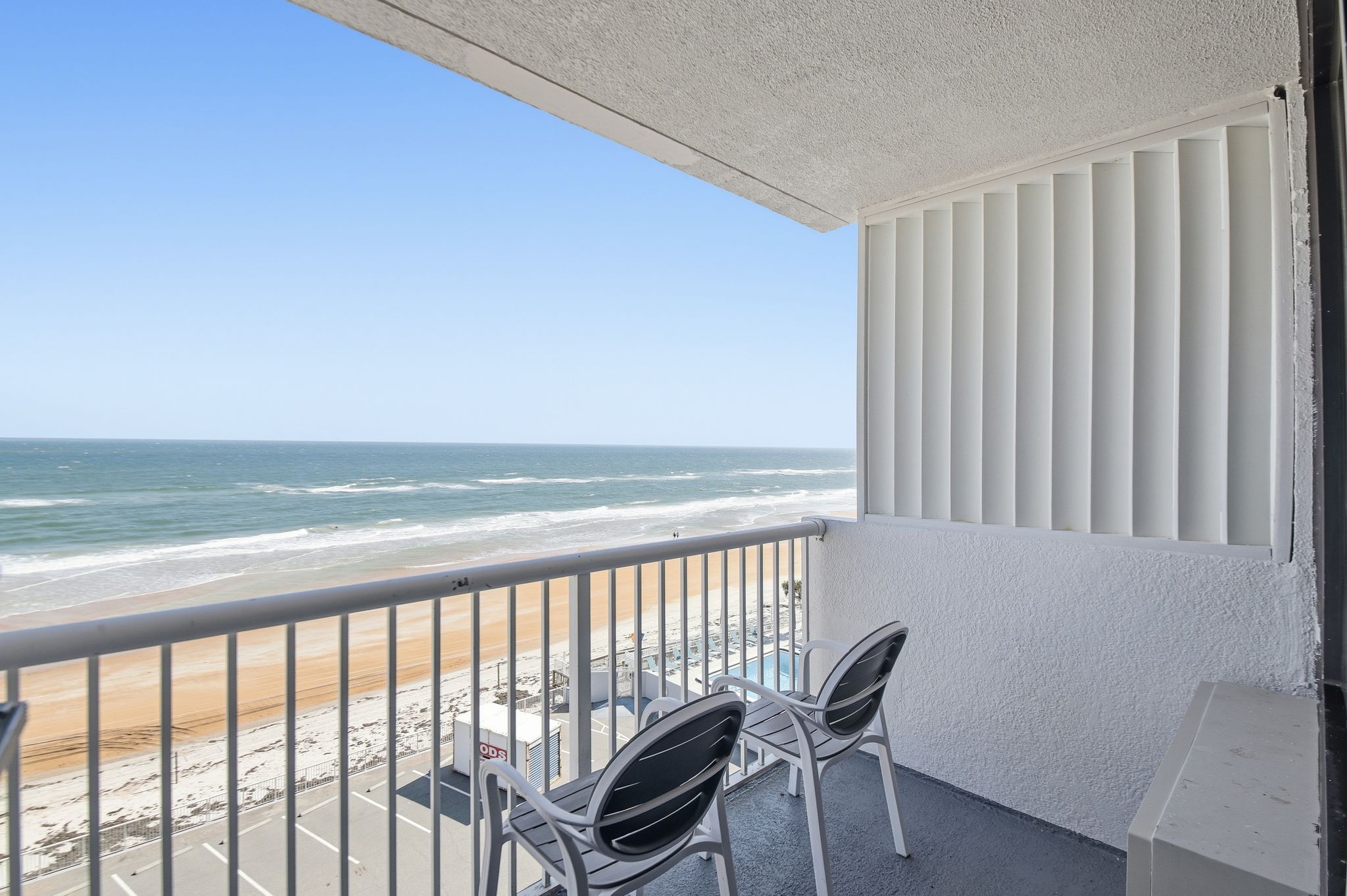 image The balcony offers a stunning ocean vista, where gentle waves meet sandy shores, perfect for sipping morning coffee while soaking in the sun and sea breeze.