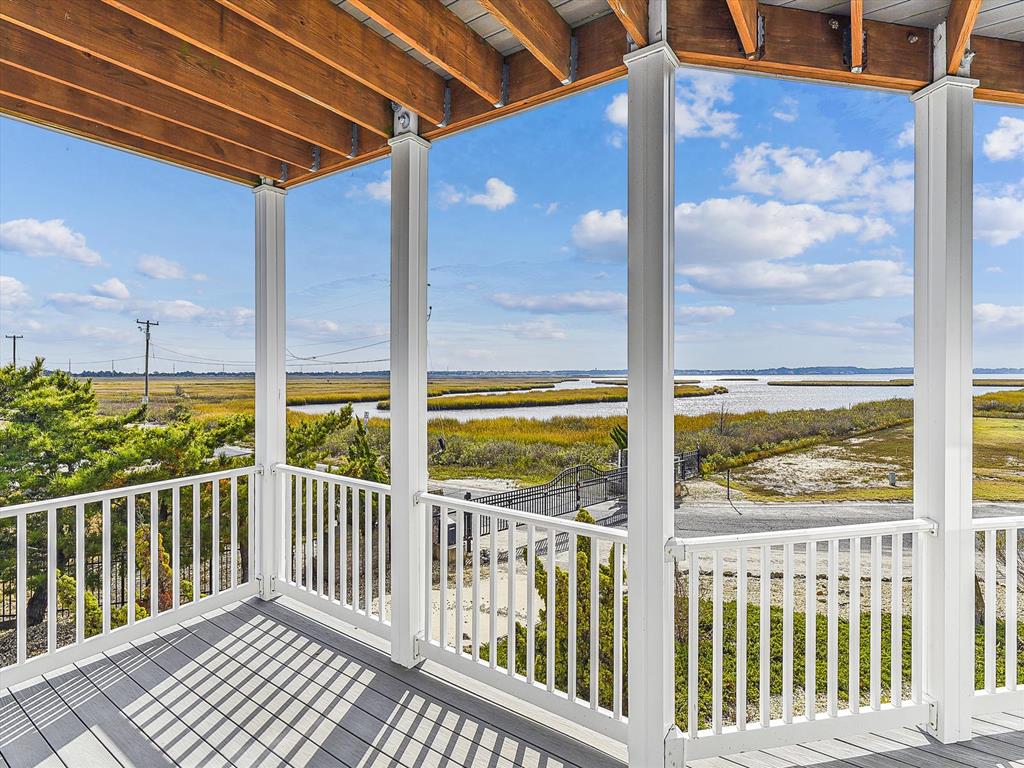 image Stunning wraparound deck showcasing uninterrupted marsh and water views from every angle.