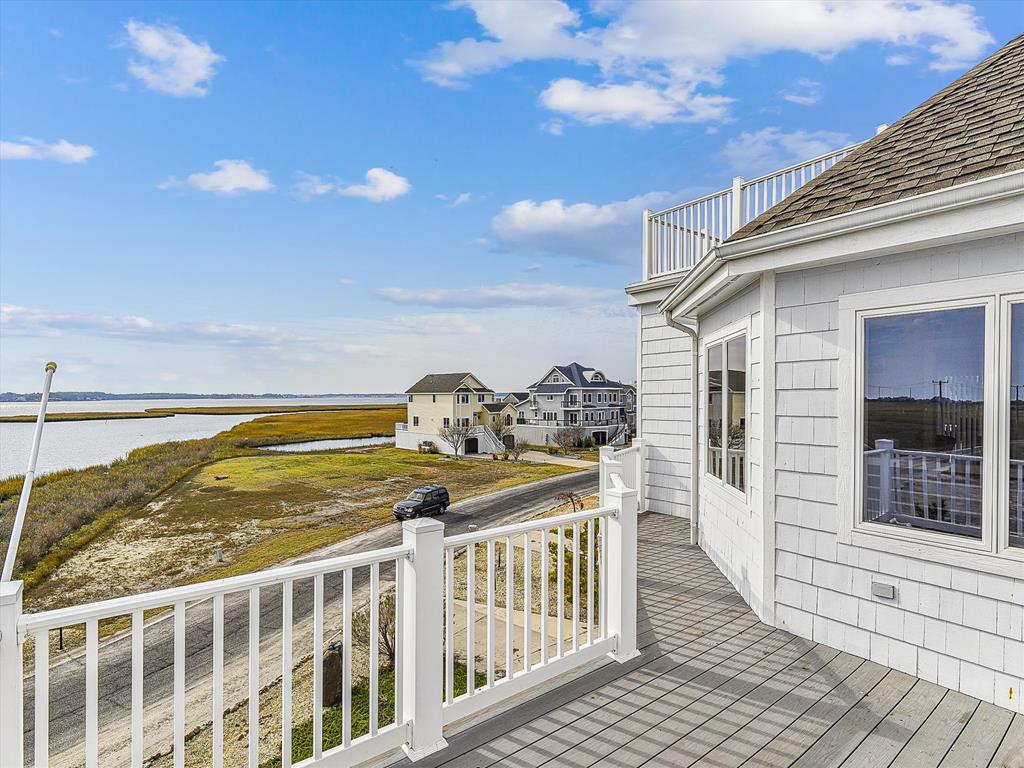 image Elevated deck with sweeping marsh and water views, ideal for relaxing and soaking in coastal scenery.