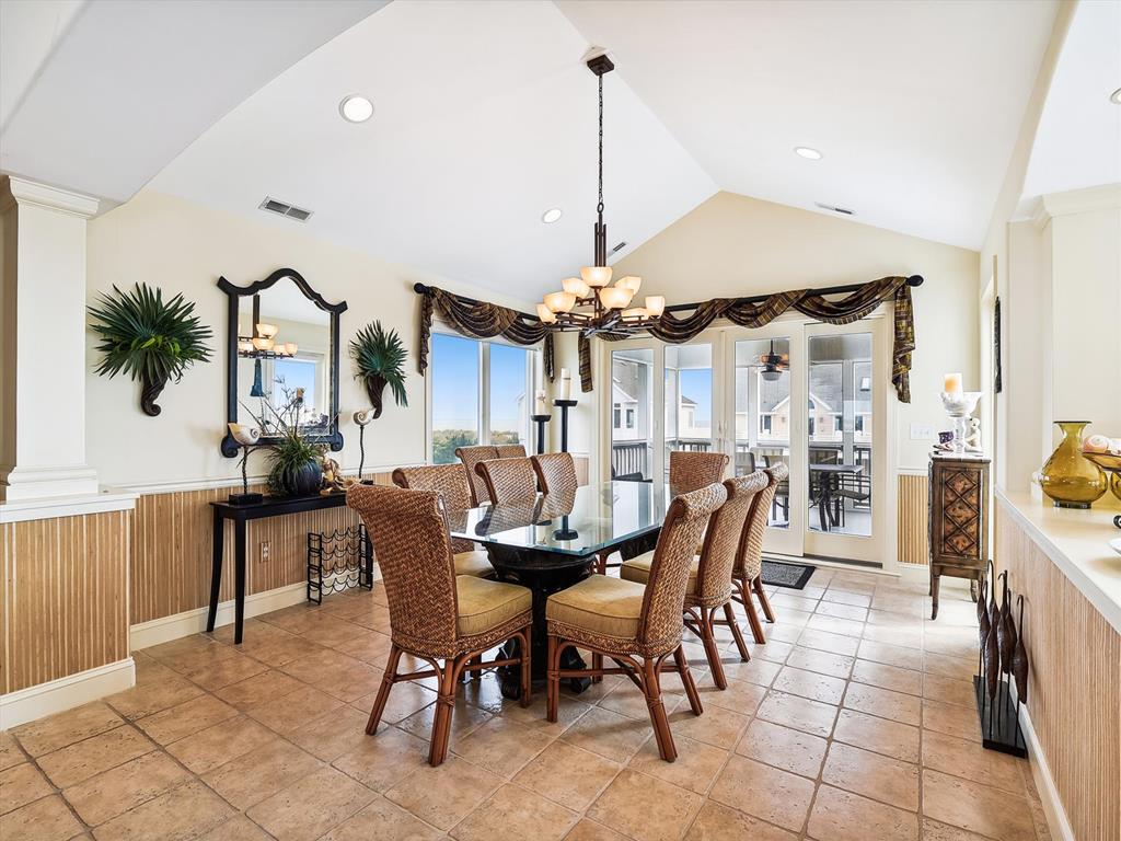 image The elegant dining area is bathed in natural light, with beautiful ocean views through large windows, creating an inviting atmosphere for sharing meals with family and friends.