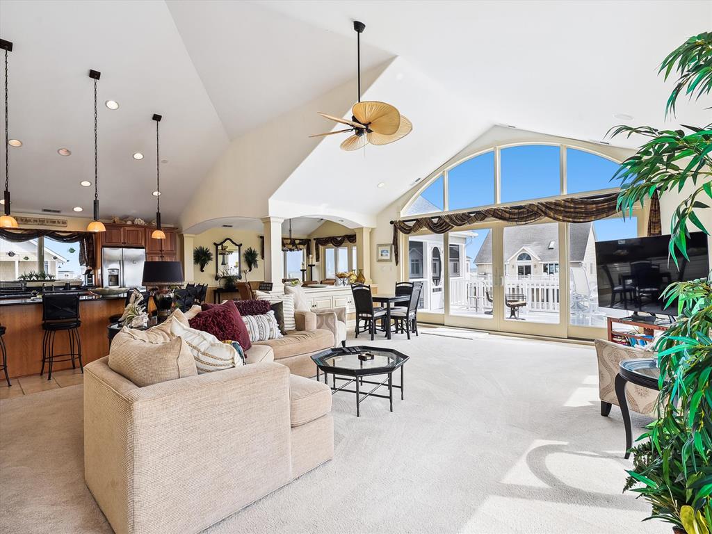 image This expansive living room, adorned with modern comforts and large windows, offers breathtaking views of the coastline, seamlessly blending indoor luxury with outdoor beauty.