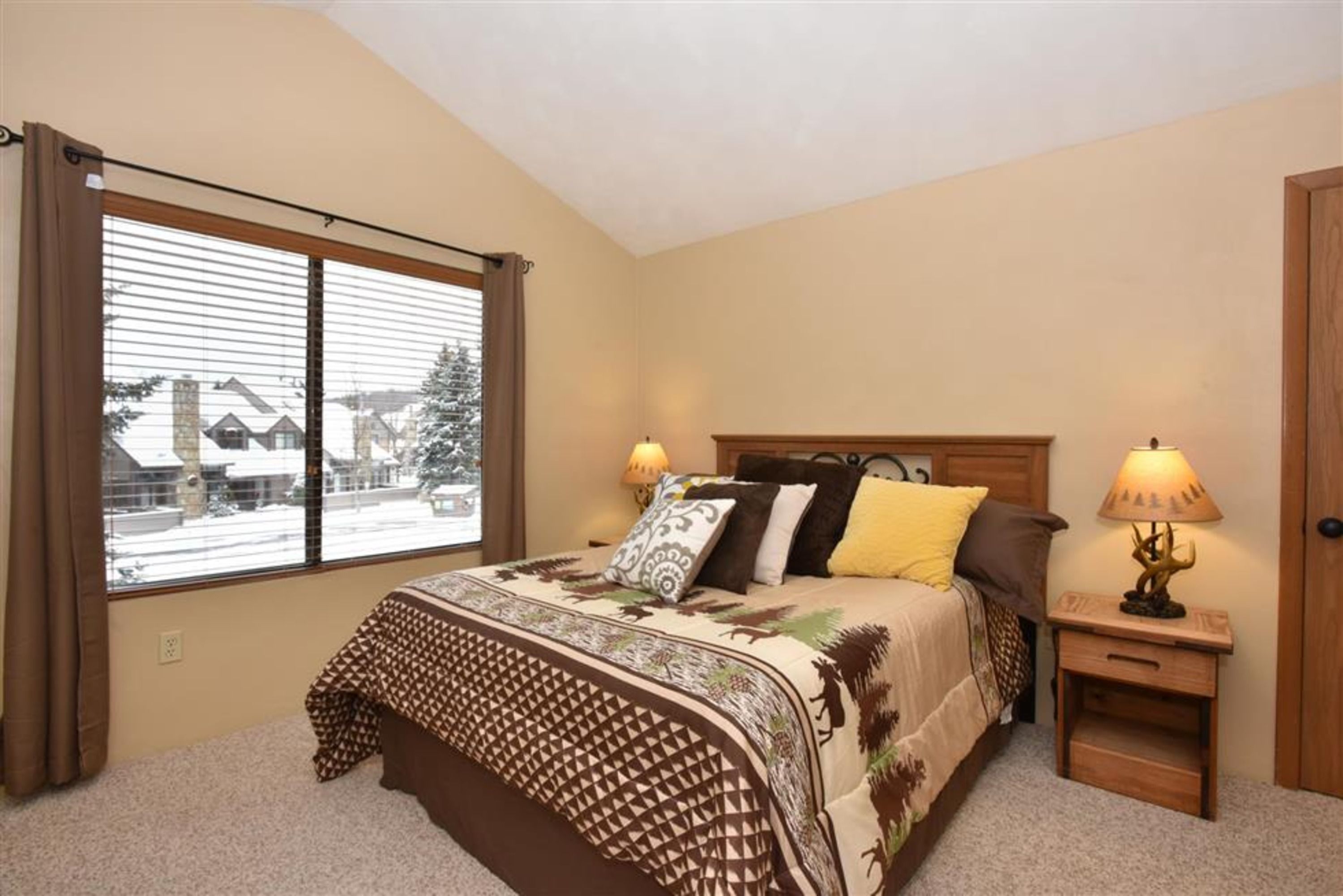 image Serene bedroom with plush queen bed, warm lighting, and scenic views right outside your window.
